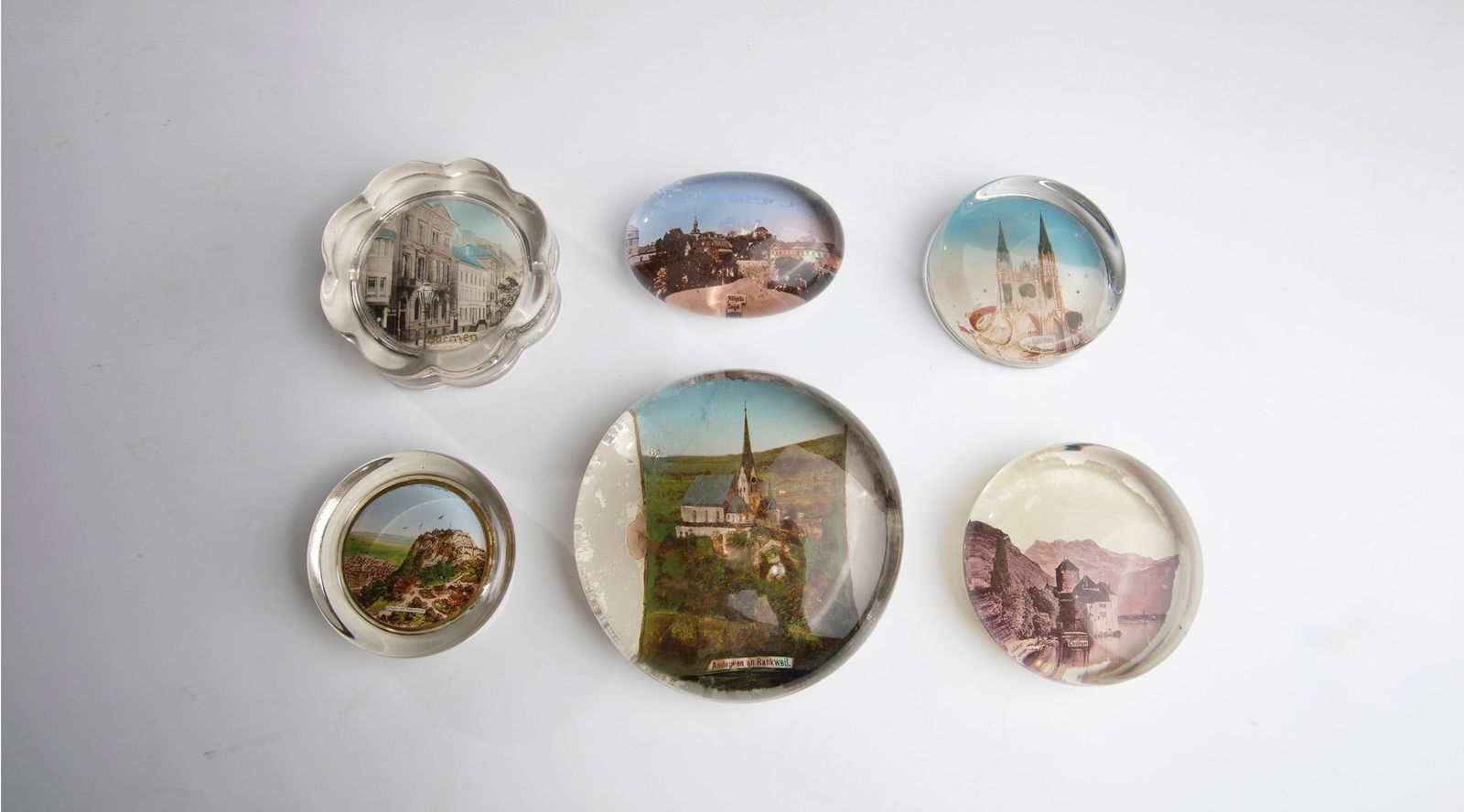 Fifteen Paperweights: Fifteen paperweights 20th century. Fifteen small paperweights made of glass with different views.D.4.5-6.7cm.