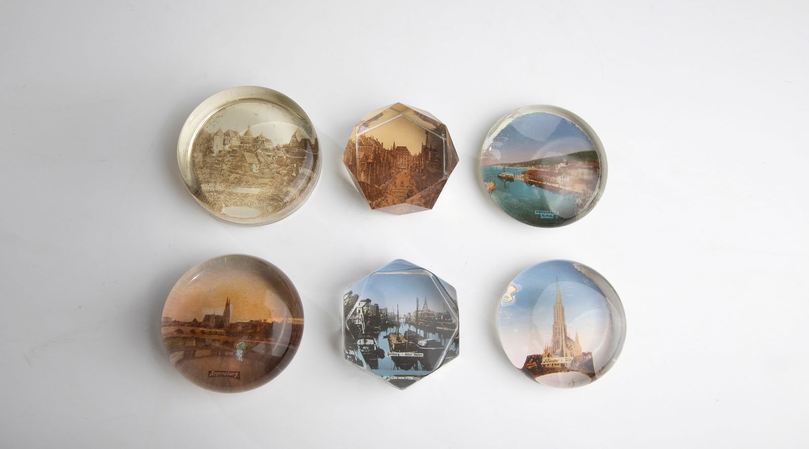 Thirteen Paperweights: Thirteen paperweights 20th century Fifteen small paperweights made of glass with different views. D.5.2-7.4cm.