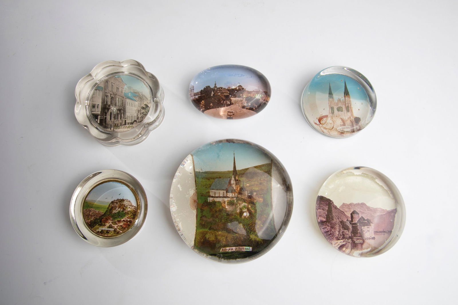 Fifteen Paperweights: Fifteen paperweights 20th century Fifteen small paperweights made of glass with different views. D.4.9-10.7cm.