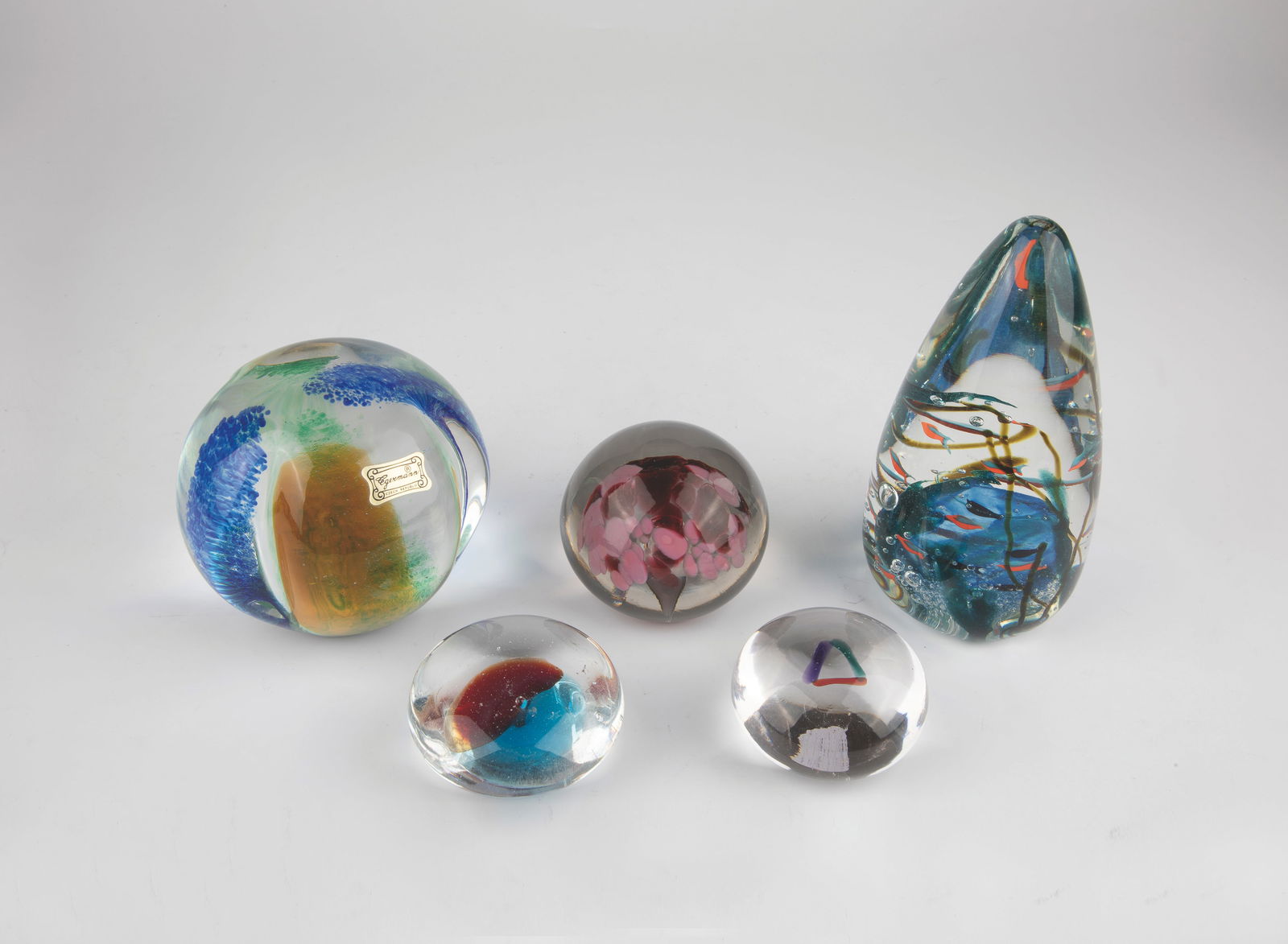 Five Paperweights: Five paperweights, 20th century, paperweight made of glass. One with the original label ''Magic Art'' and the second label ''Egermann''. Another with original label ''Gordon Studio'' and signature