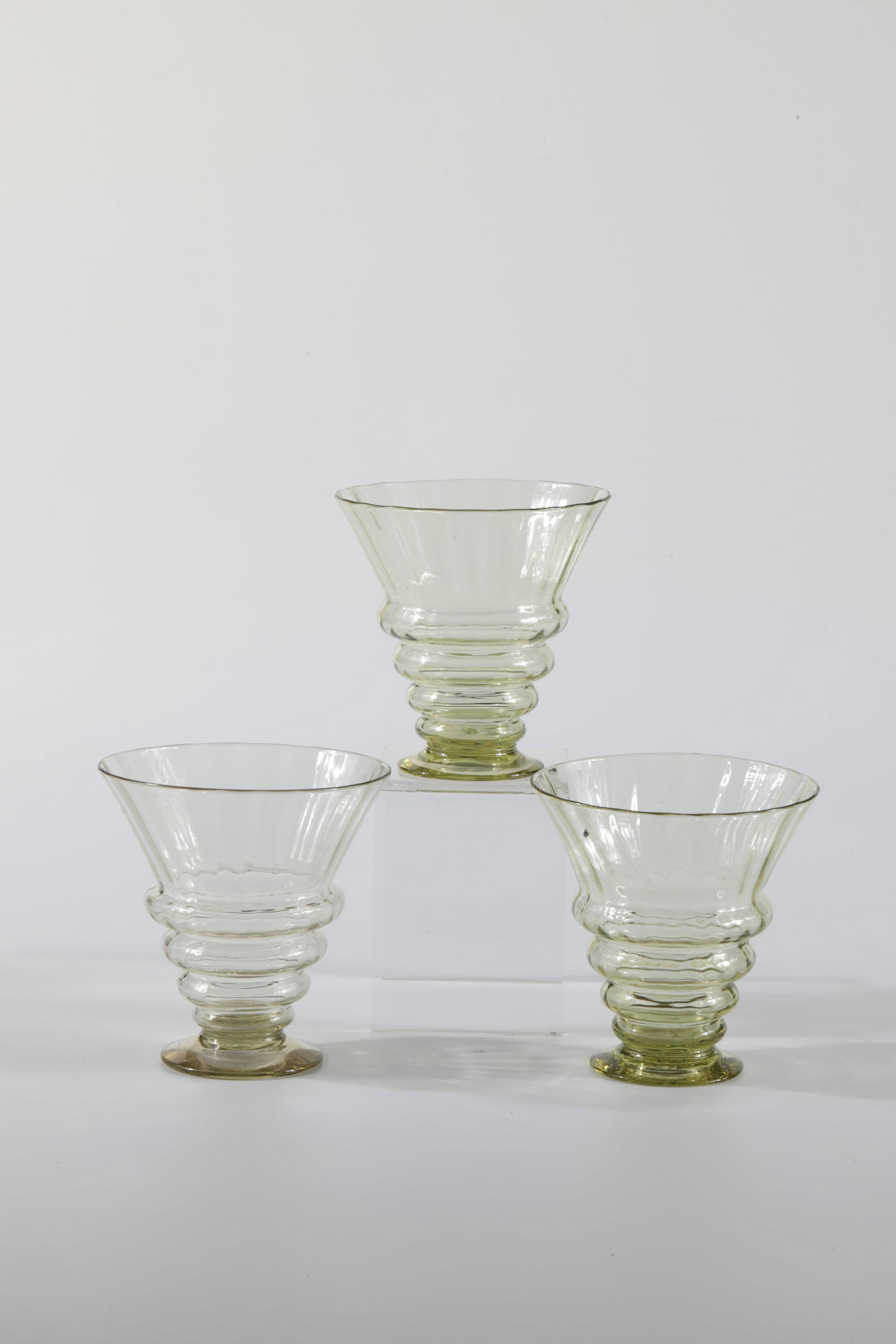 Three Venetian Puff Cups: Three Venetian puff cups Rheinische Glashütten AG, Cologne-Ehrenfeld, around 1881 Three Venetian puff cups for wine, olive-coloured glass. One with an etching mark Ehrenfeld.H: 8 cm.