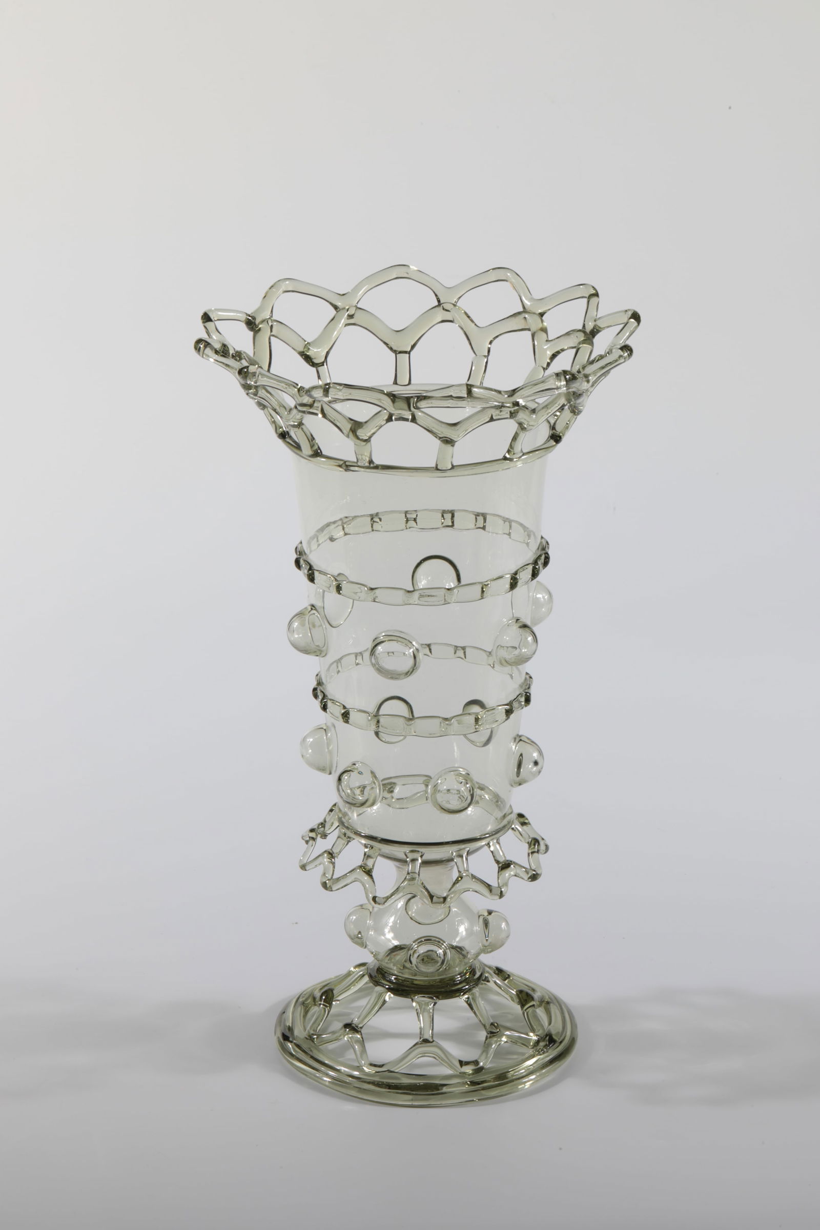 Flower vase: Flower vase Rheinische Glashütten AG, Cologne-Ehrenfeld, c. 1881 Olive-coloured glass. Openwork foot, the hollow stem with 4 hollow-blown nubs, which are also located on the body of the vase together