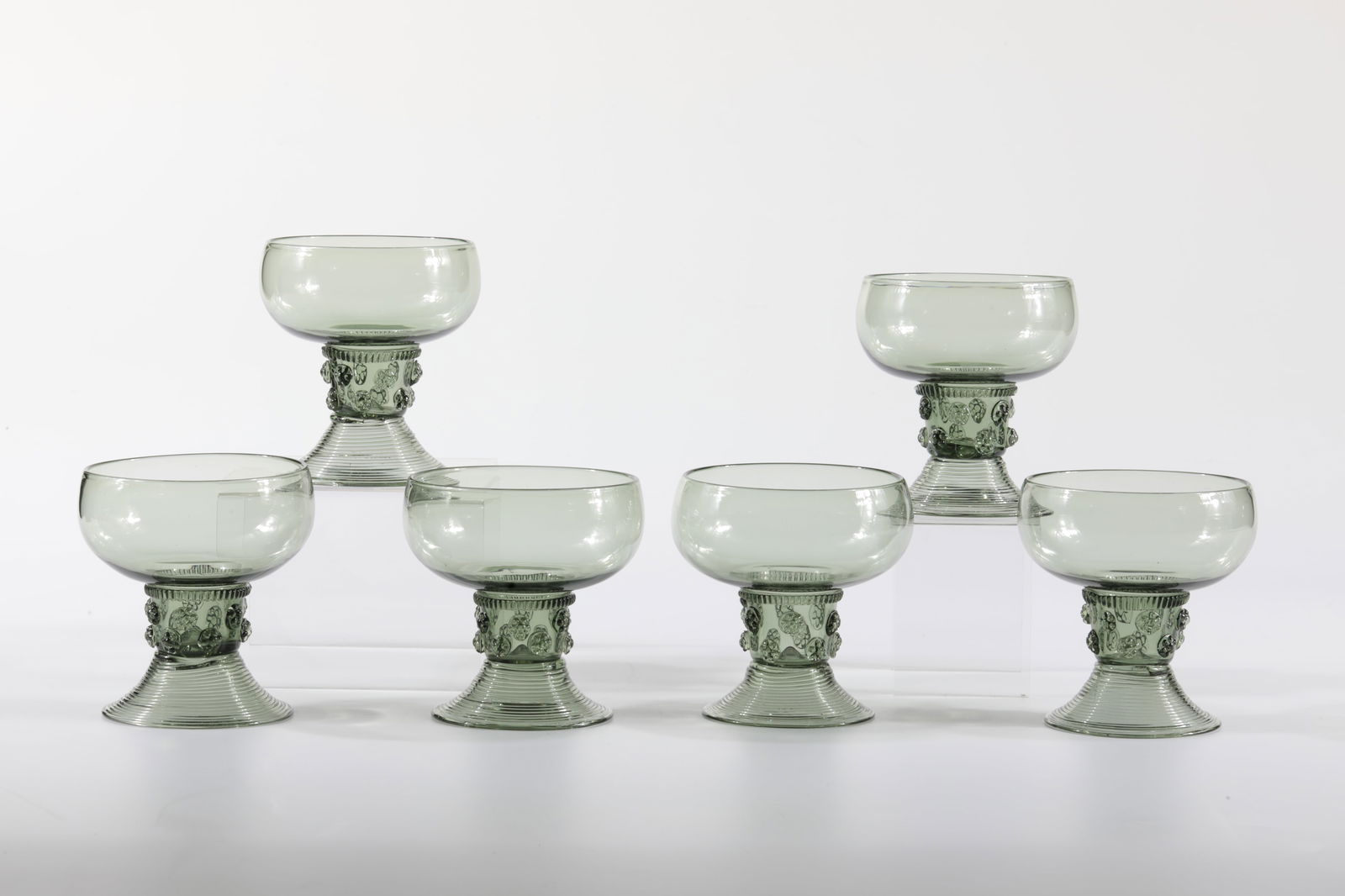 Six Romans Thewald: Six Römer Thewald Rheinische Glashütten AG, Cologne-Ehrenfeld, around 1881 Antique green glass. Ribbed thread, twelve small nubs and spun foot. H: 9.5 cm.