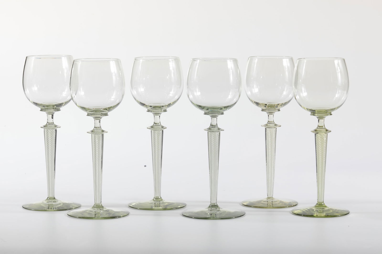 Set six Moselle wine Römer ''Wilhelm'': Set of six Moselle wine Römer ''Wilhelm'' Rheinische Glashütten AG, Cologne-Ehrenfeld, around 1881 Light moss green glass. Stem with spiral air stripes. H: 19.5 cm.