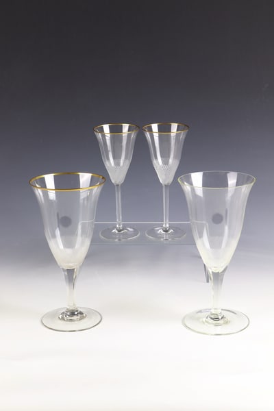 Four goblets ''Lloyd'': Four goblet glasses ''Lloyd'' Tyra Lundgren (design), Moser, Karlovy Vary, 1922 Colourless glass with six-faceted shaft. Below the cuppa, fine stone grinding. Three glasses with gilded muzzle rim; a