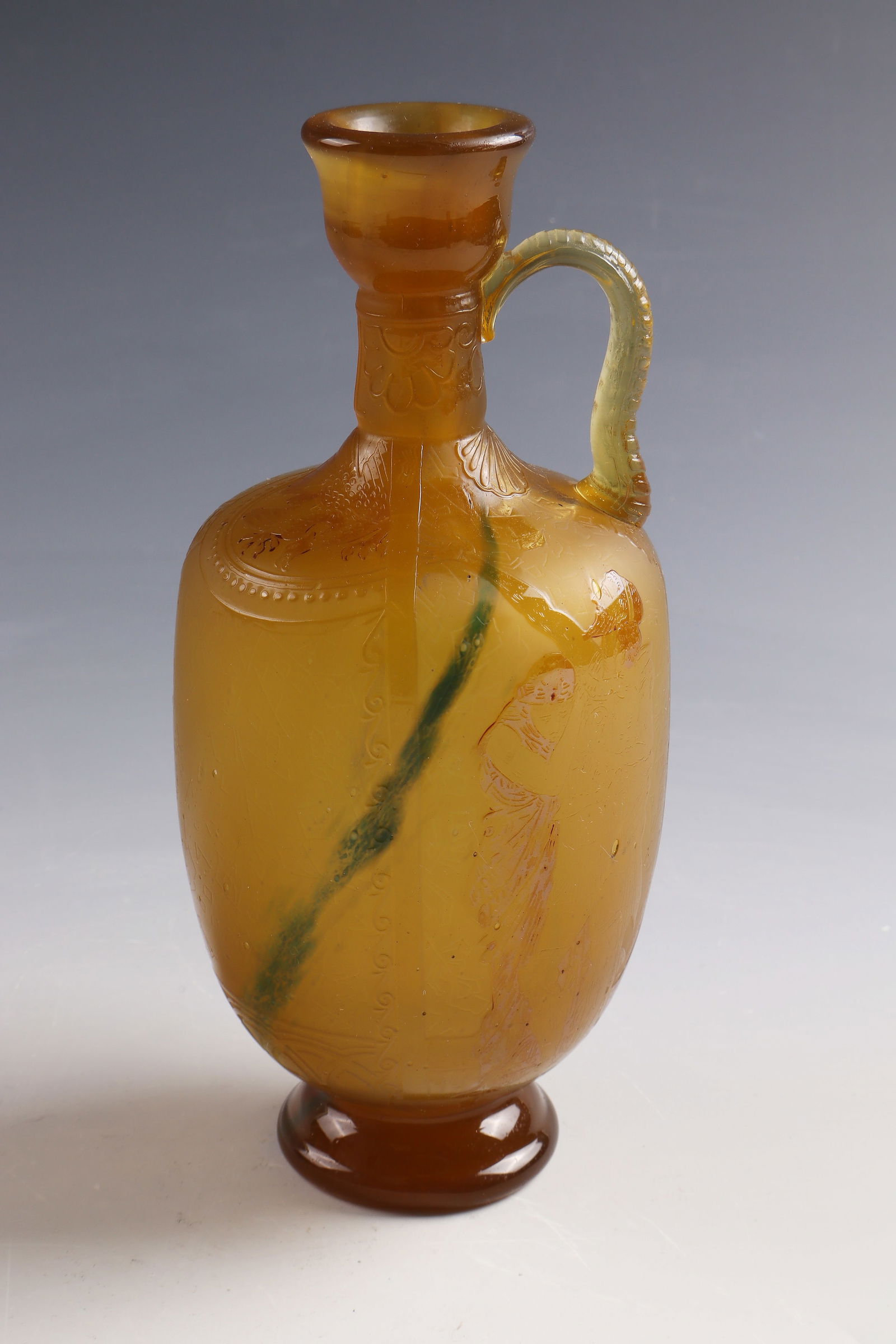 Jug with Mythological Decoration after Walter Crane: Jug with mythological decoration after Walter Crane Burgun, Schverer & Co., Meisenthal/Lorraine, c. 1894 Honey-brown glass, partially with oxide melting. Circumferential relief etched decoration with