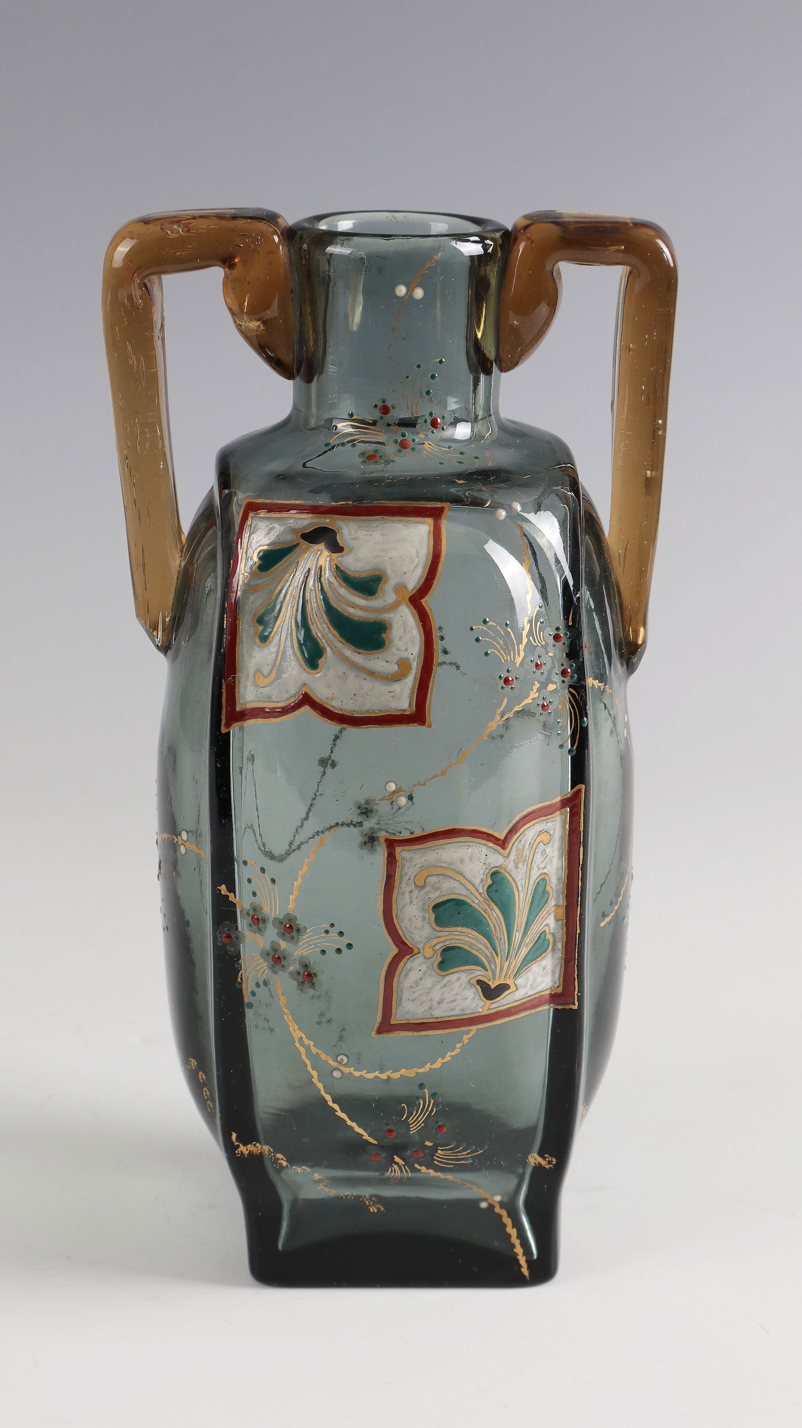 Handle vase with japonizing decoration: Handle vase with japonizing decoration Cristallerie de Clichy, 1874 - 1876 Blue-gray glass with gold and colorful opaque enamel decoration. Attached handles in brown-yellow. H. 23 cm Lit.: G. Cappa,