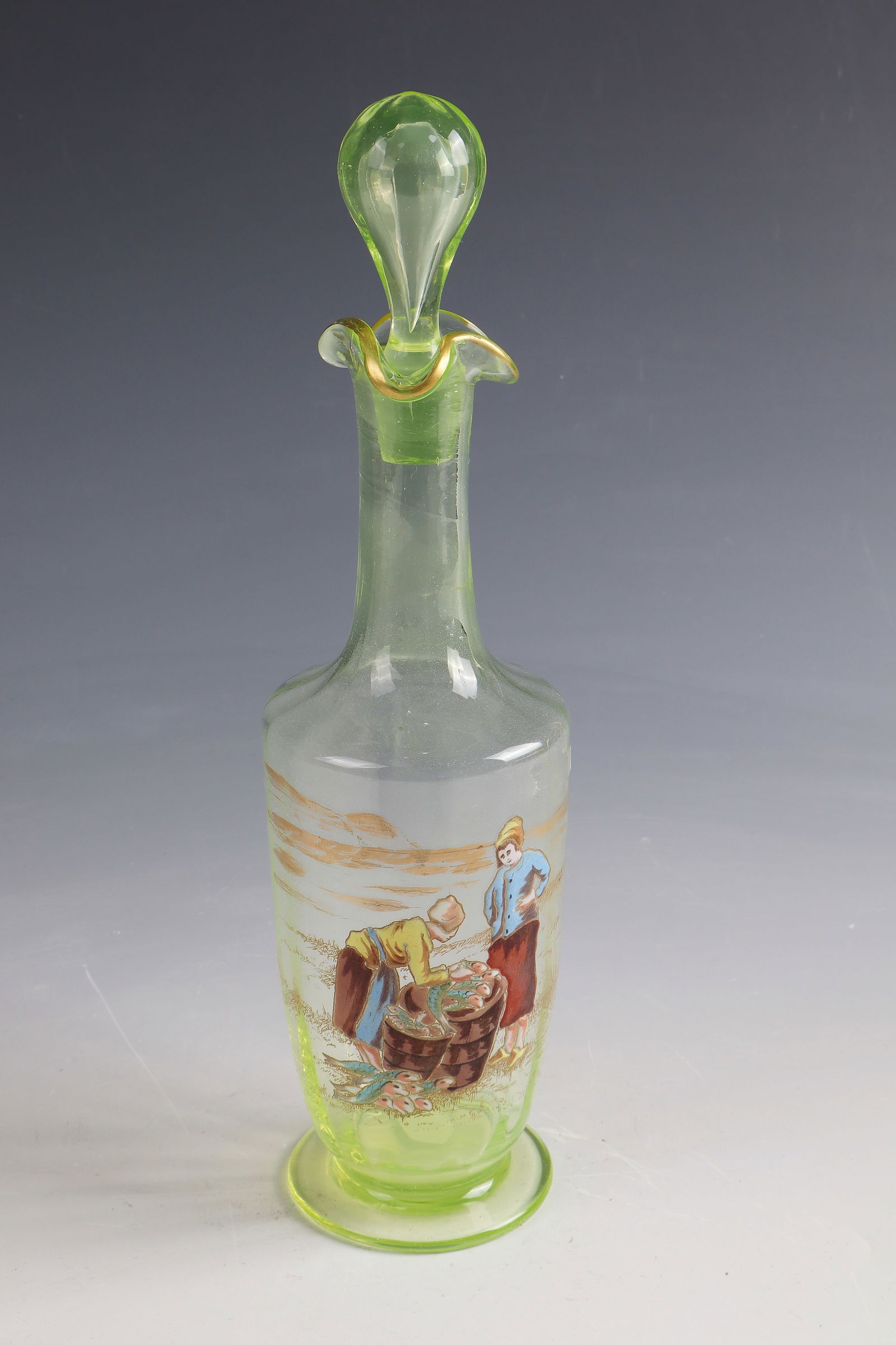 Carafe with fishermen on the beach ''Poissonnières'': Carafe with fishermen on the beach ''Poissonnières'' Cristallerie de Clichy, 1890 - 1900 Light green uranium glass with gold and coloured opaque enamel. H. 18.5 cm Lit.: G. Cappa, Le Genié Verrier