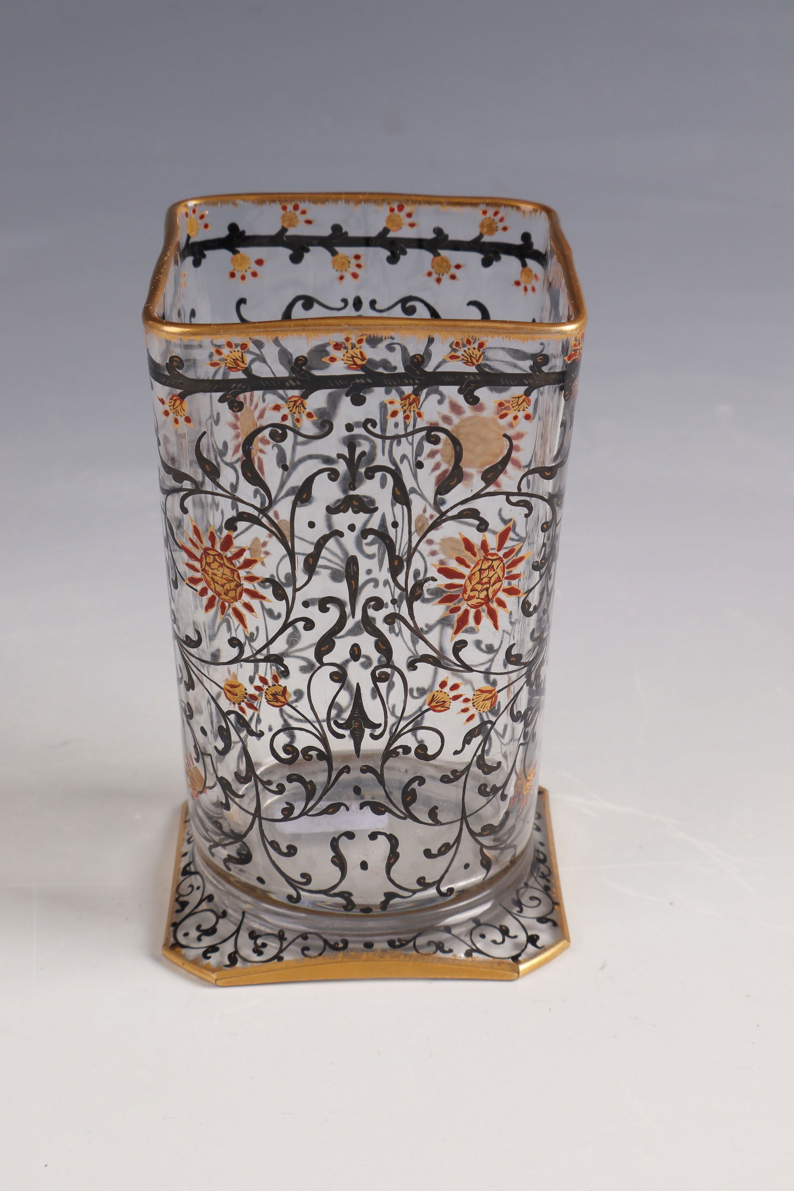 Small goblet vase ''Fleurettes et rinceaux'': Small Beaker Vase ''Fleurettes et rinceaux'' Daum Frères, Nancy, circa 1892 Colorless glass painted in black solder, gold and brown opaque enamel. Underside inscribed: Daum Nancy with Lorraine cross