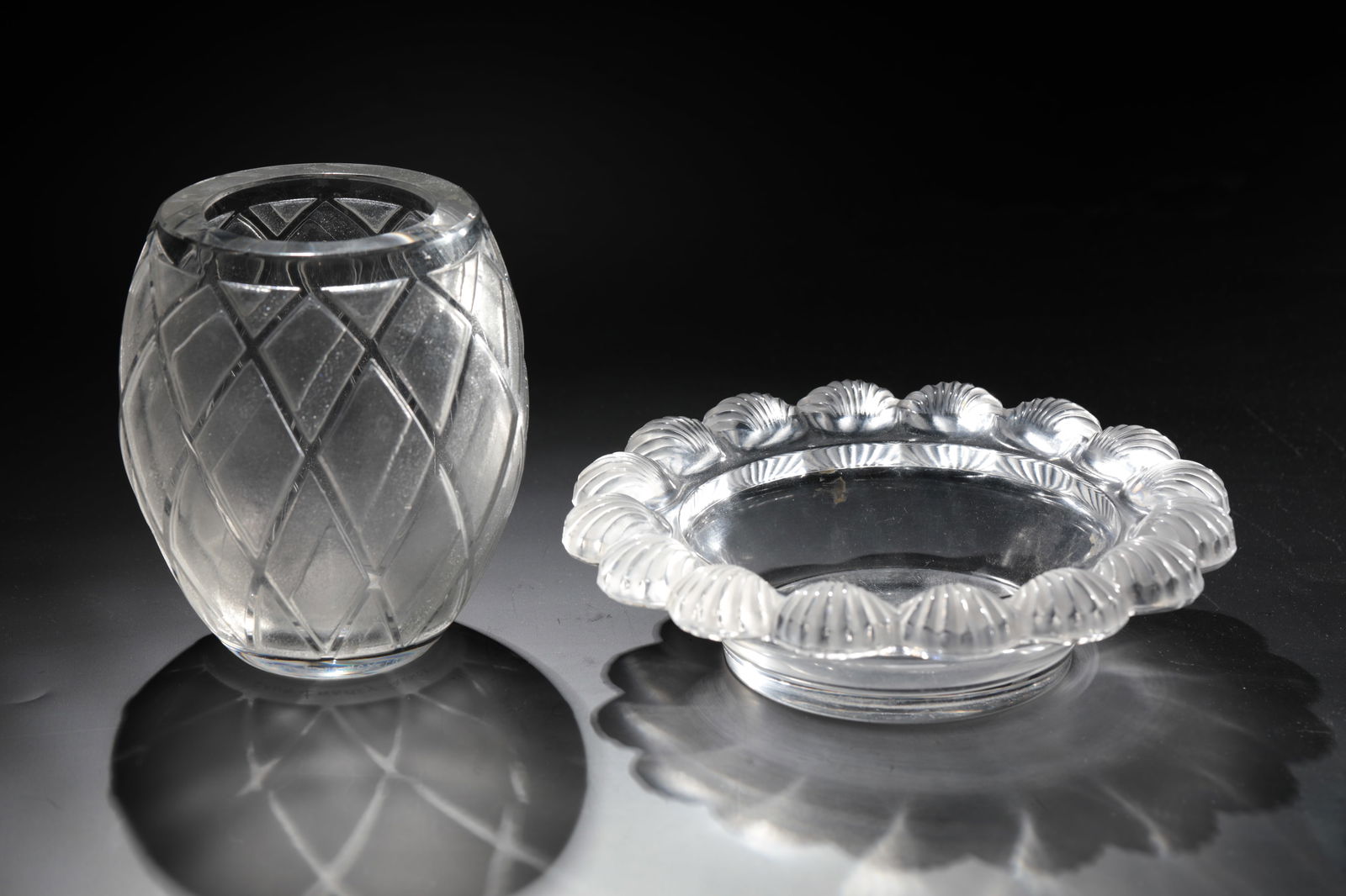 Bowl ''Coquilles'' and a vase: Bowl ''Coquilles'' and a vase René Lalique, Wingen - sur - Moder, c. 1950 - Daum Frères, Nancy, 1925 - 1930 Colourless glass, moulded or etched, cut and polished. References: Lalique France (engrave