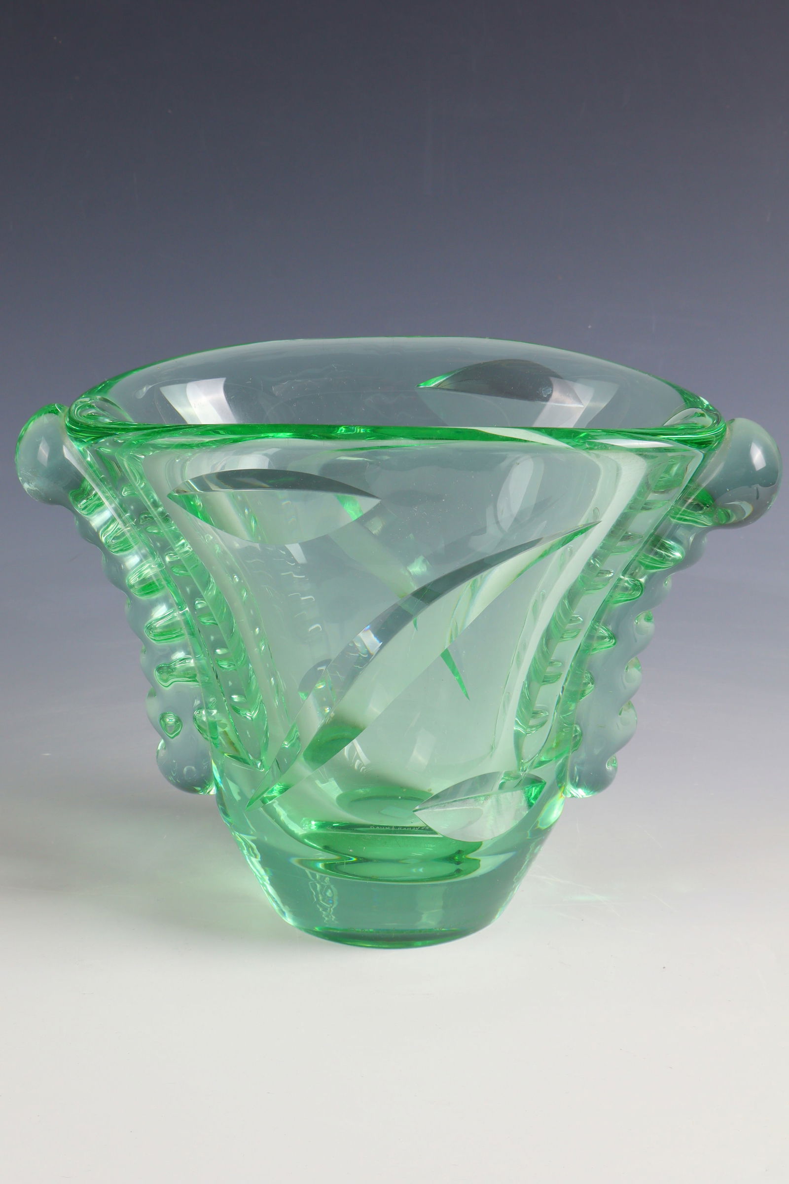 Vase: Vase Daum Frères, Nancy, 1930 - 1936 Green, thick-walled glass, cut and polished. Side appliqués. Reference: DAUM NANCY (engraved). H. 19 cm Lit.: G. Cappa, Le Genié Verrier de l'Europe, ed.: Marda