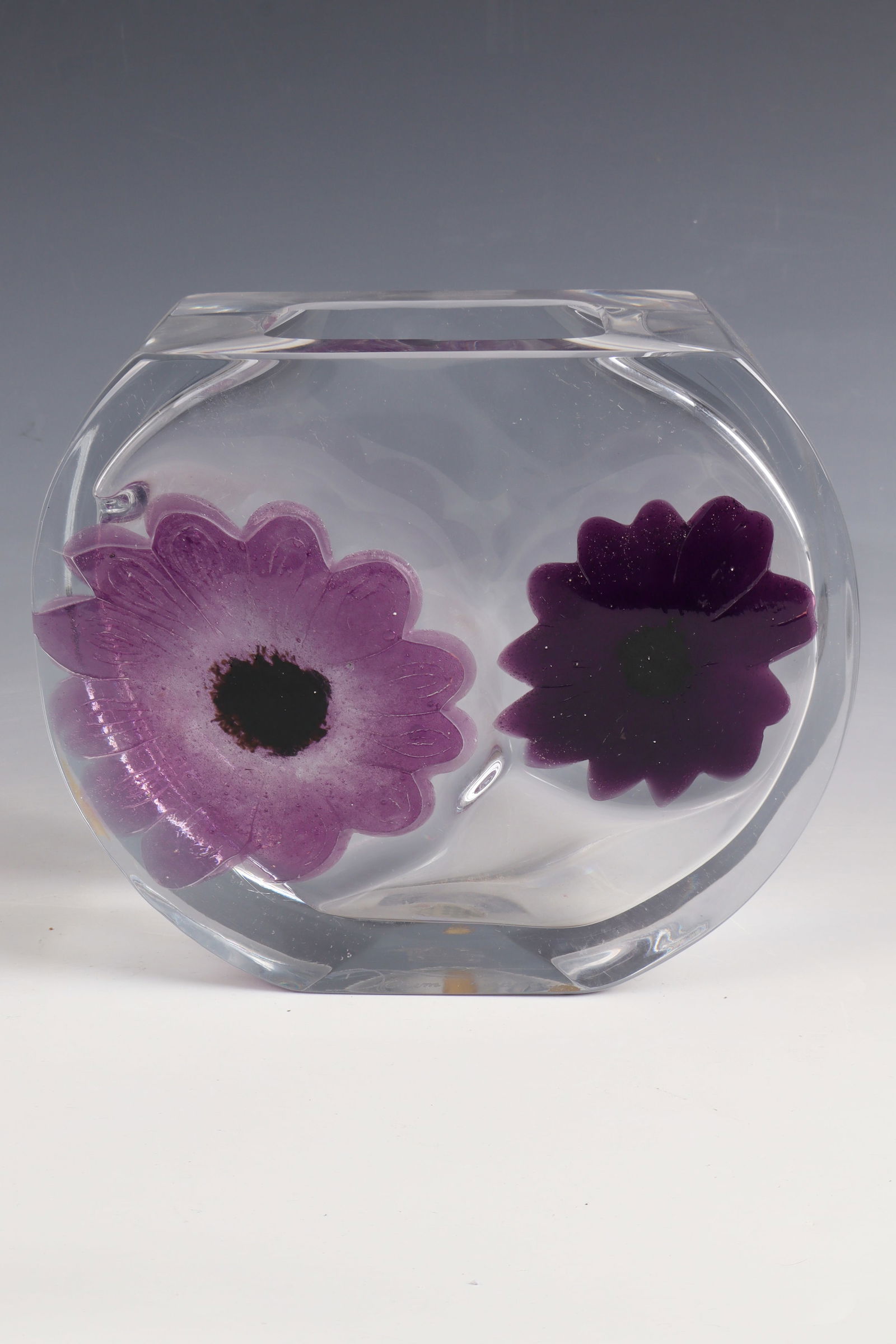 Vase ''Coppelia'': Vase ''Coppelia'' Daum, 1977 Colourless, thick-walled glass with plastically fused anemone flowers in light and dark purple pâte de verre. Reference: Daum (engraved). H. 18 cm Lit.: G. Cappa, Le