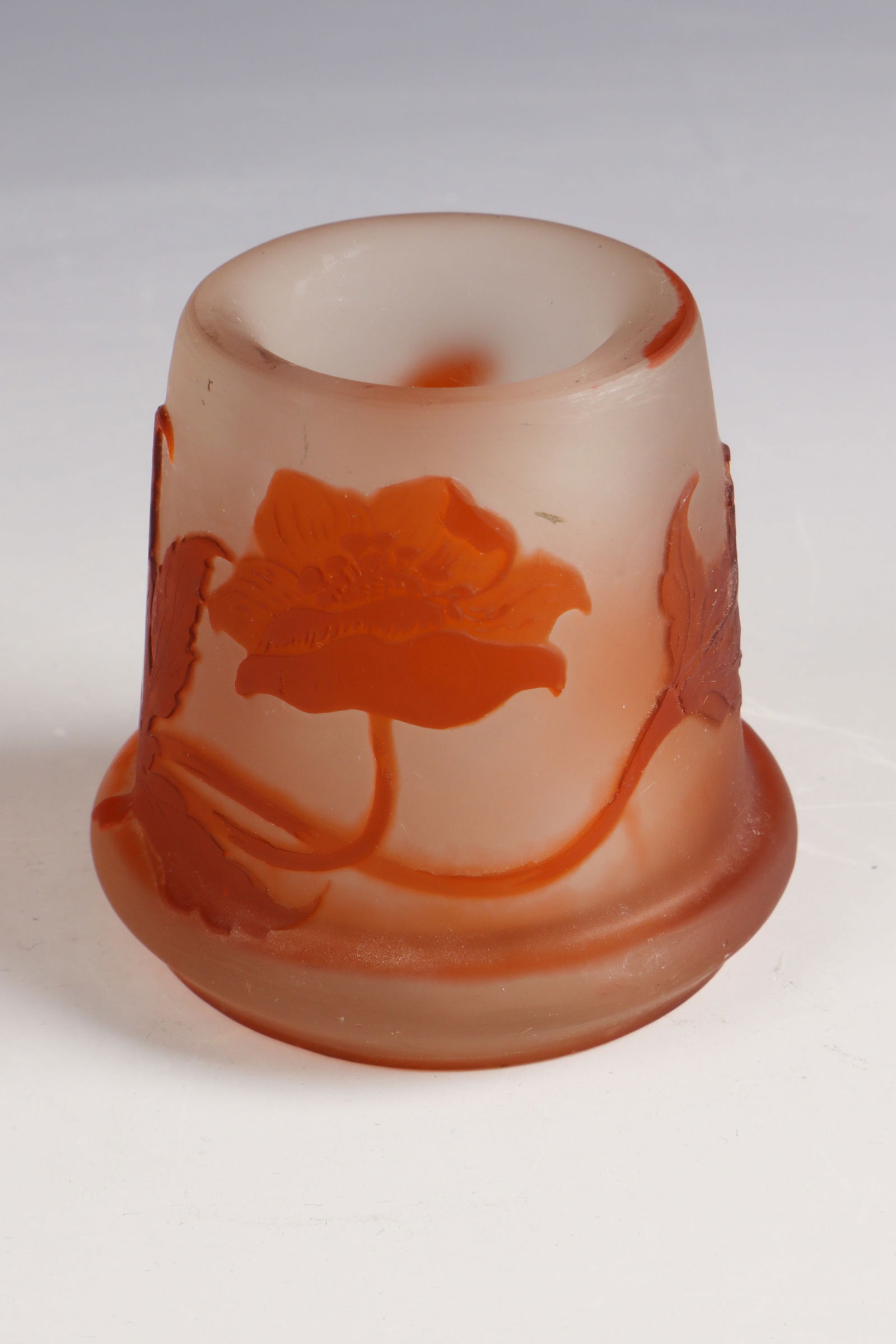 Small vase with poppy seeds ''Pavots'': Small vase with poppies ''Pavots'' Emile Gallé, Nancy, c. 1904 Colourless frosted glass, orange-brown overlay. Relief etched décor. Reference: Gallé (highly etched). H. 7 cm
