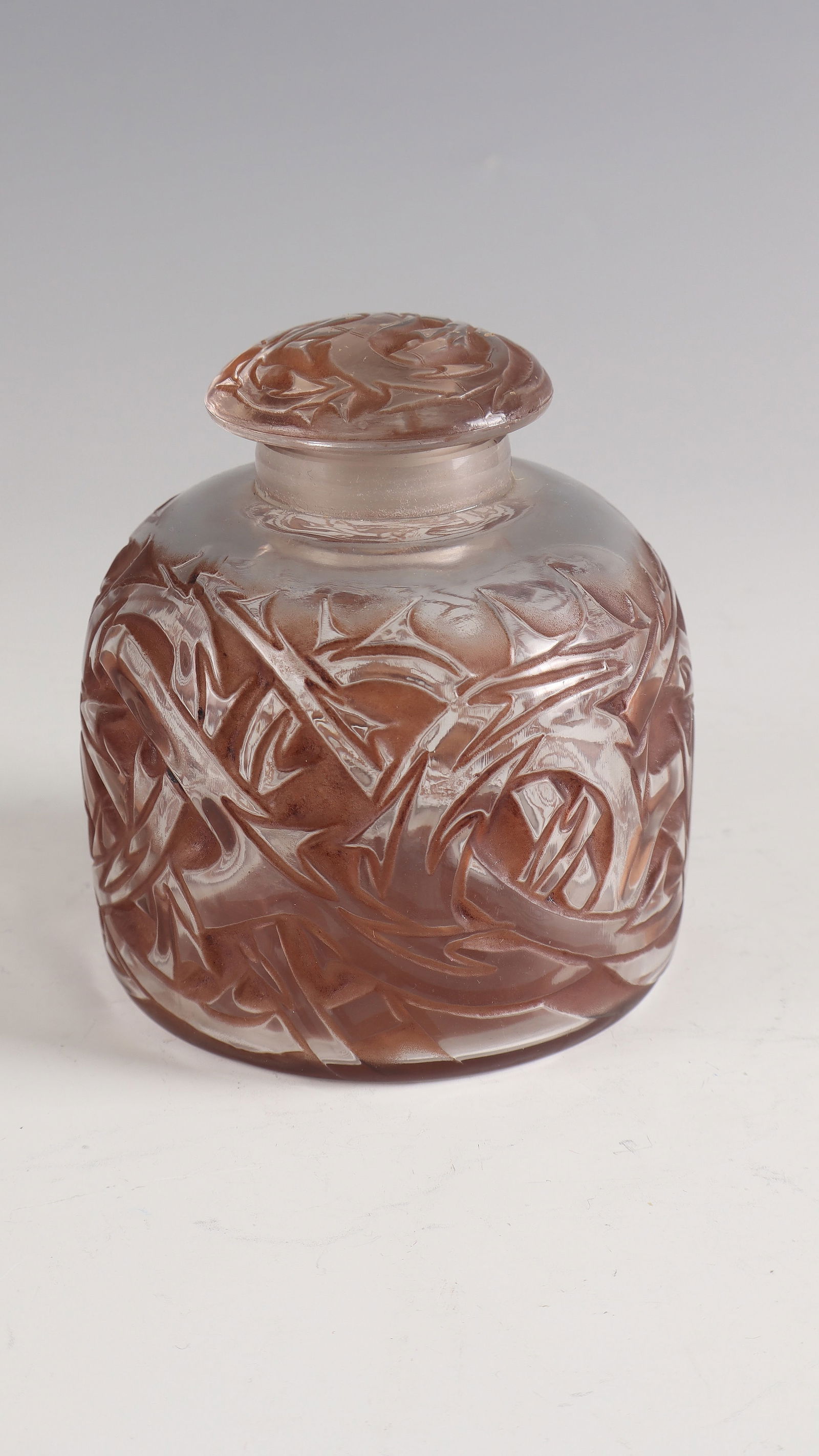 Bottle with stopper N° 2 ''Épines'': Bottle with stopper N° 2 ''Épines'' René Lalique, Wingen - sur - Moder, 1920 Colourless glass, moulded and partially patinated with dark brown. Underside inscribed: R. LALIQUE (deep-pressed). H.