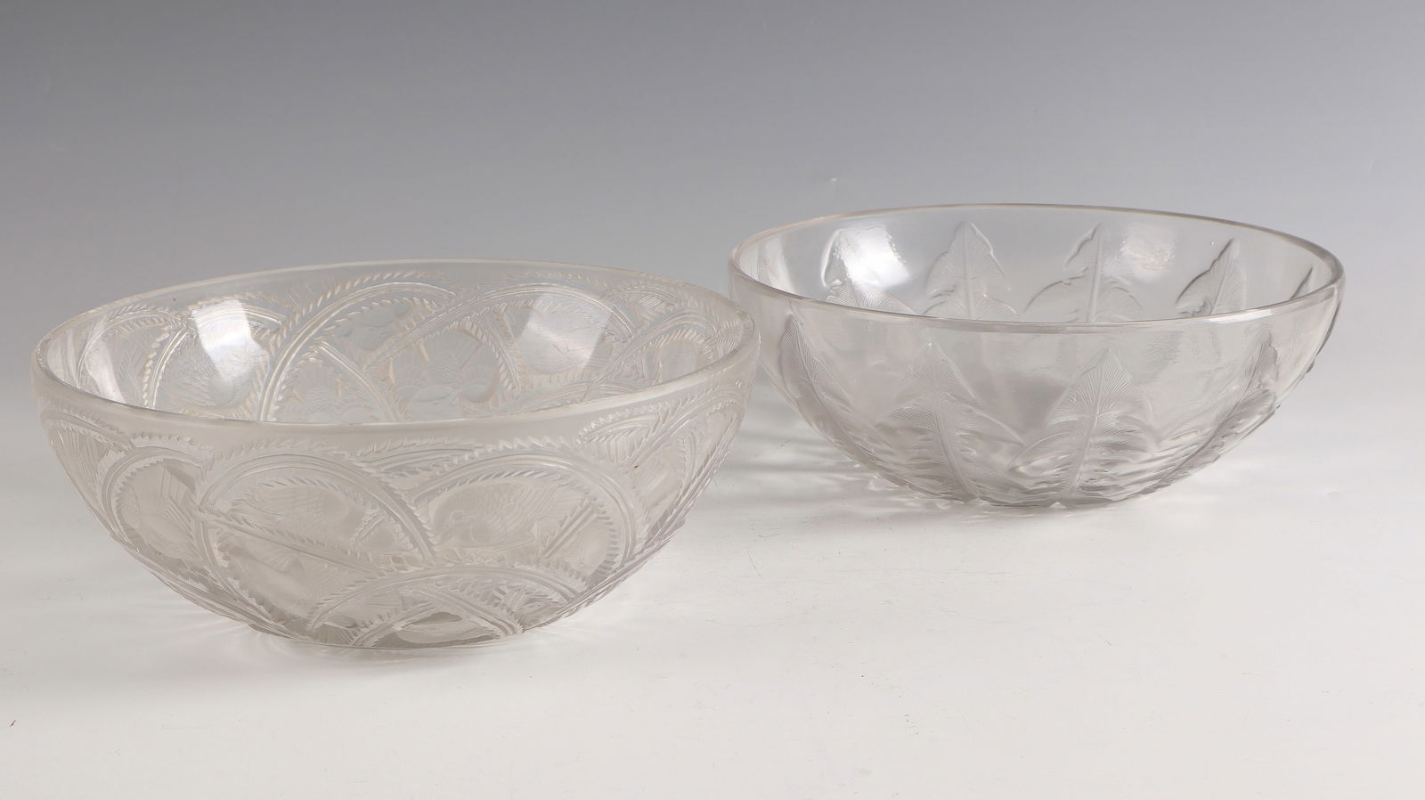 2 bowls ''Pissenlit N° 1'' - ''Pinsons'': 2 bowls ''Pissenlit N° 1'' - ''Pinsons'' René Lalique, Wingen - sur - Moder, 1921 and 1933 Colourless glass, moulded, finished with polish. Reference: R. LALIQUE FRANCE or Lalique France