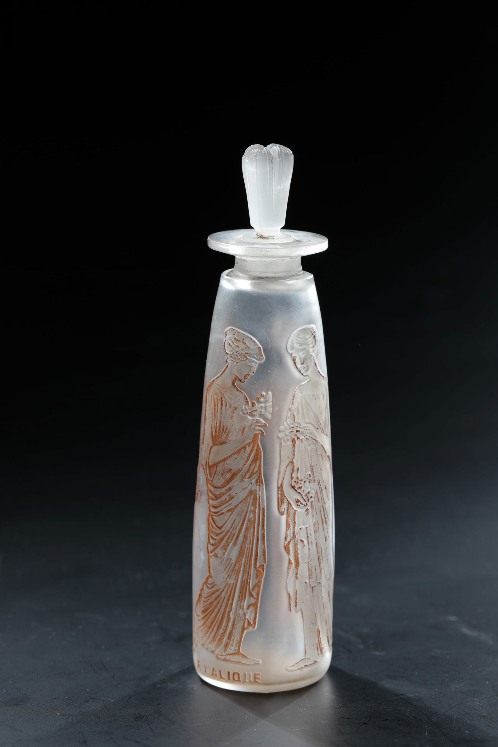 Bottle ''Ambre antique'' for Coty: Bottle ''Ambre antique'' for Coty René Lalique, Wingen - sur-Moder, 1910 Colourless, moulded glass, brown patina. Ref.: R. LALIQUE (deep-pressed). H. 15.5 cm Lit.: G. Cappa, Le Genié Verrier de