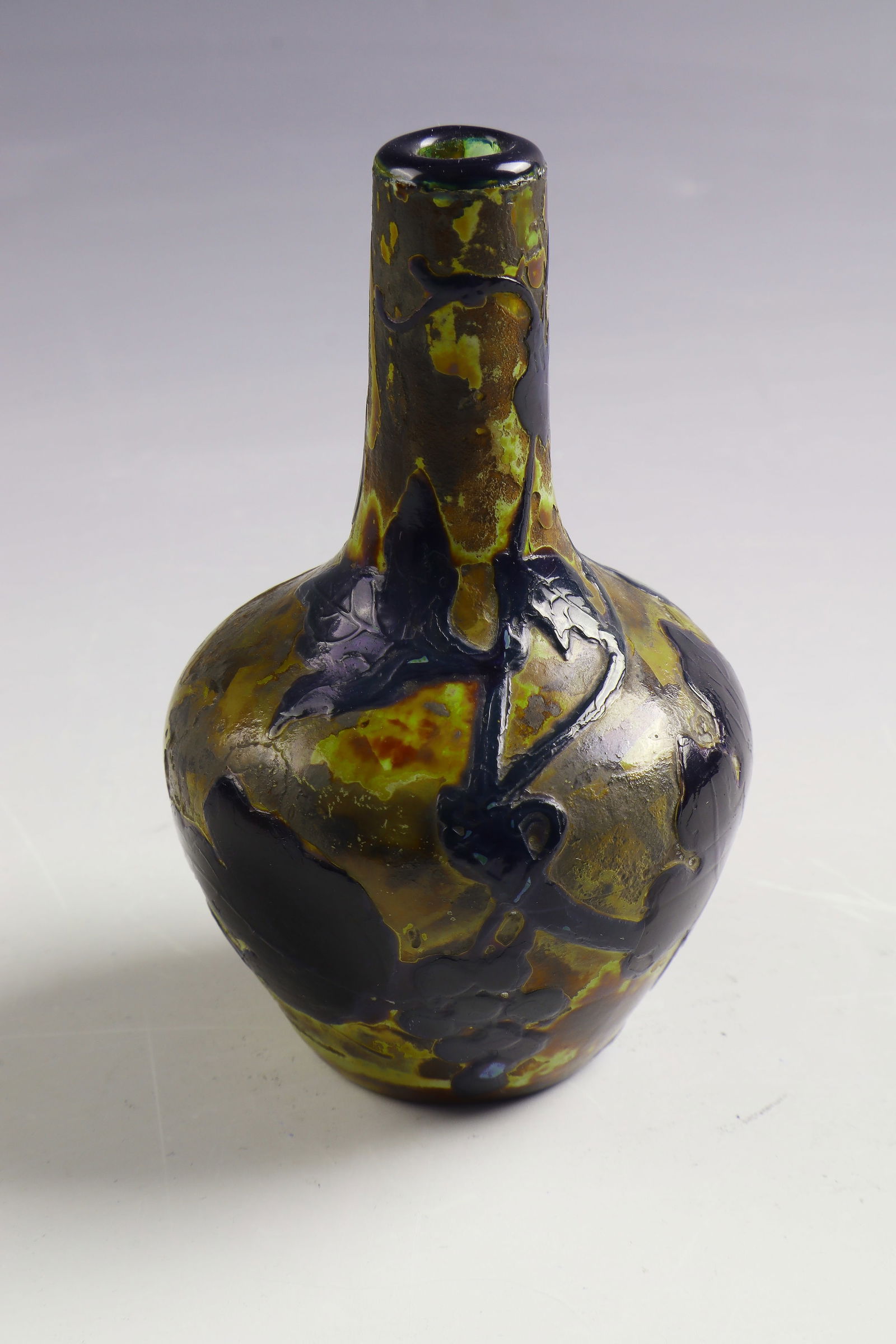 Small long-necked vase ('décor fluogravé'): Small long-necked vase ('décor fluogravé') Muller Frères, Croismare, 1905 - 1910 Colourless, dark reddish-brown overlaid glass. Circumferential, flat relief decoration: grapes and foliage.