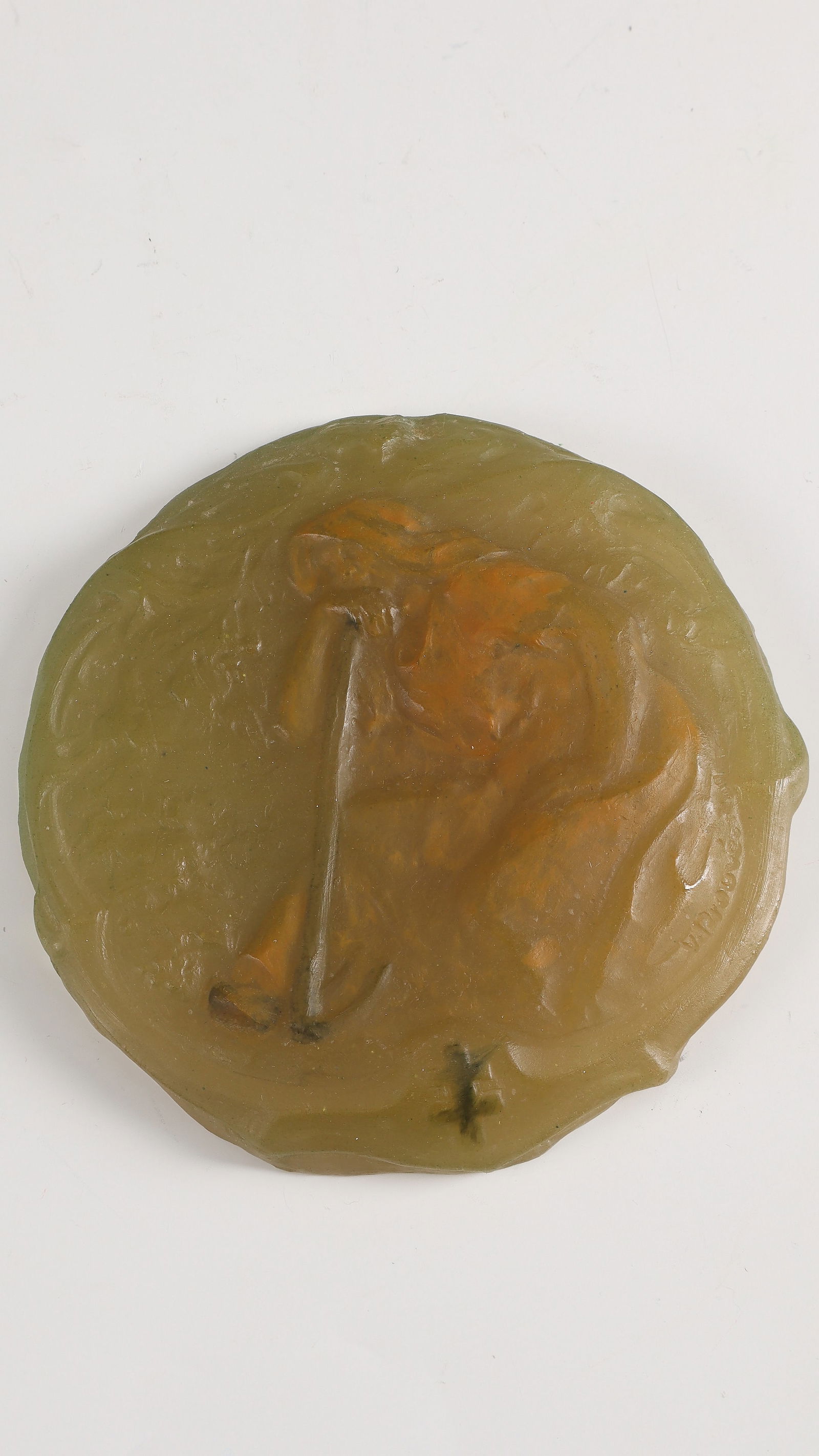 Relief plaque with seated farmer's wife and Lorraine cross: Relief plaque with seated peasant woman and Lorraine cross Victor Prouvé, 1909 Pâte de verre in grey-green and orange-brown tones, moulded. Reference: V. Prouvé 1909 (compression moulded). D. 11.5