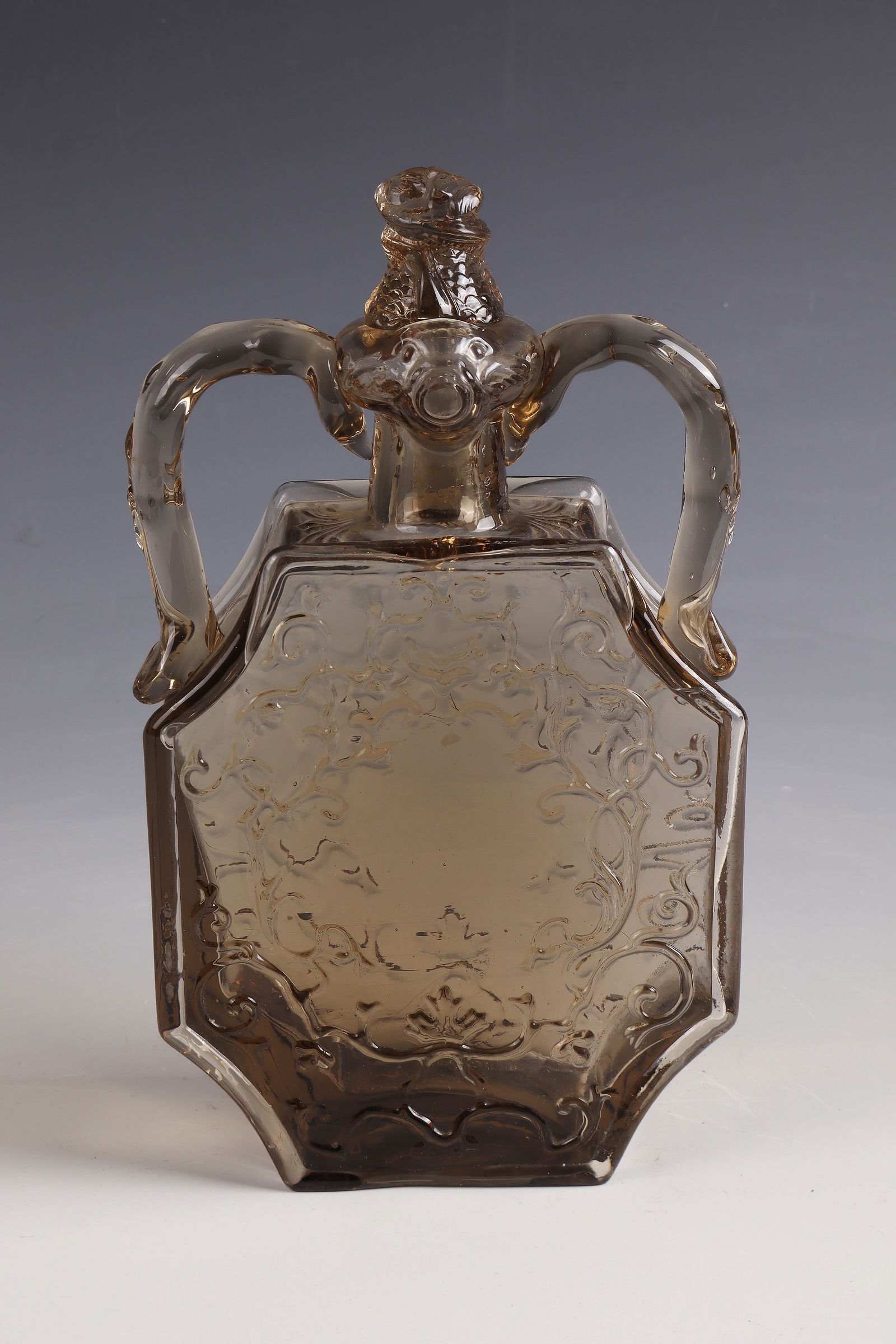 Rare Bottle ''Renaissance'': Rare bottle ''Renaissance'' Eugène Rousseau / Ernest Leveillé, around 1878 Smoky brown glass, compressed, refinished by polish. H. 25 cm Lit.: G. Cappa, Le Genié Verrier de l'Europe, ed.: Mardaga,