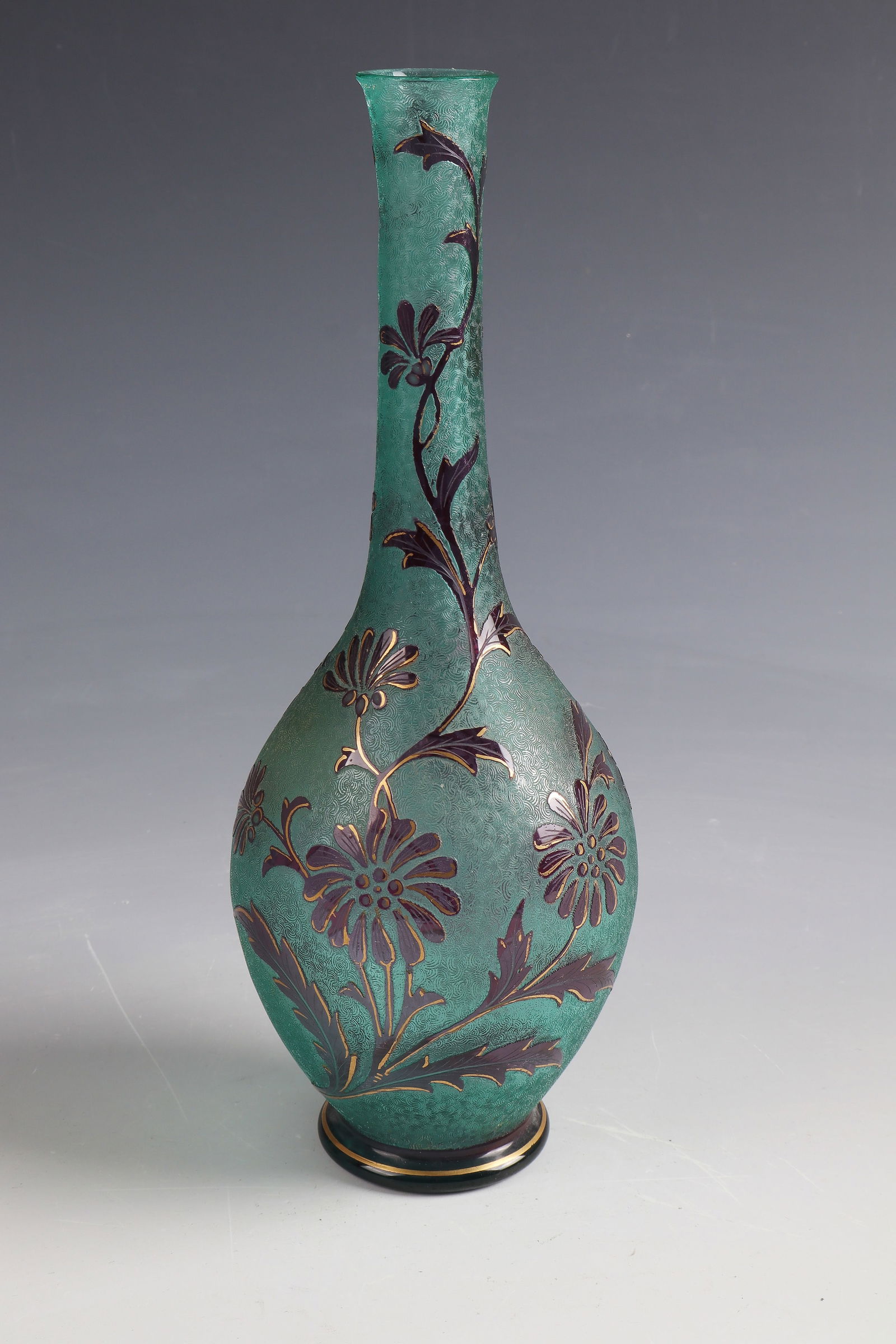 Long-neck vase with flower branch: Long-neck vase with flower branch Cristalleries de Saint-Louis, c. 1900 Blue-green glass, violet overlay. Contour and interior drawing in needle etching and polished gold. Underside inscribed: Etching