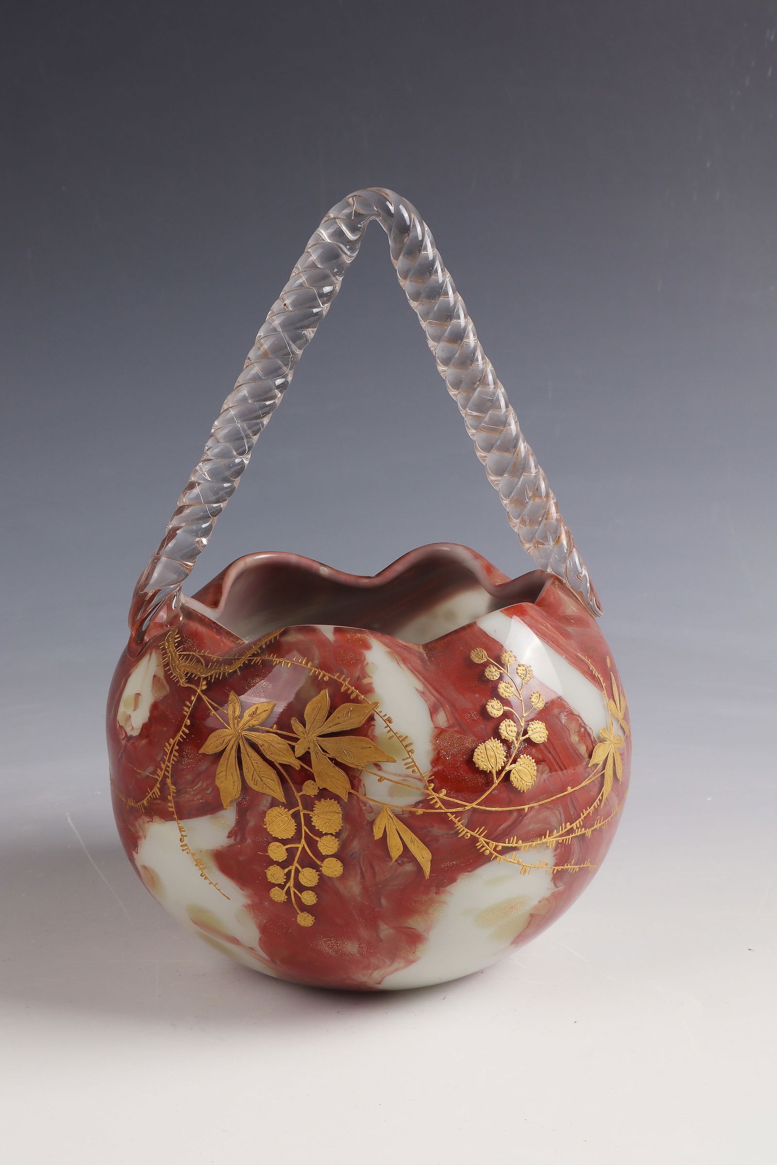 Handle basket: Basket with handles Cristallerie de Sèvres, c. 1885 - 1890 Colourless glass with white opal and reddish brown inclusions. Decorated in polished and relief gold. Attached handle in colorless. H. 24