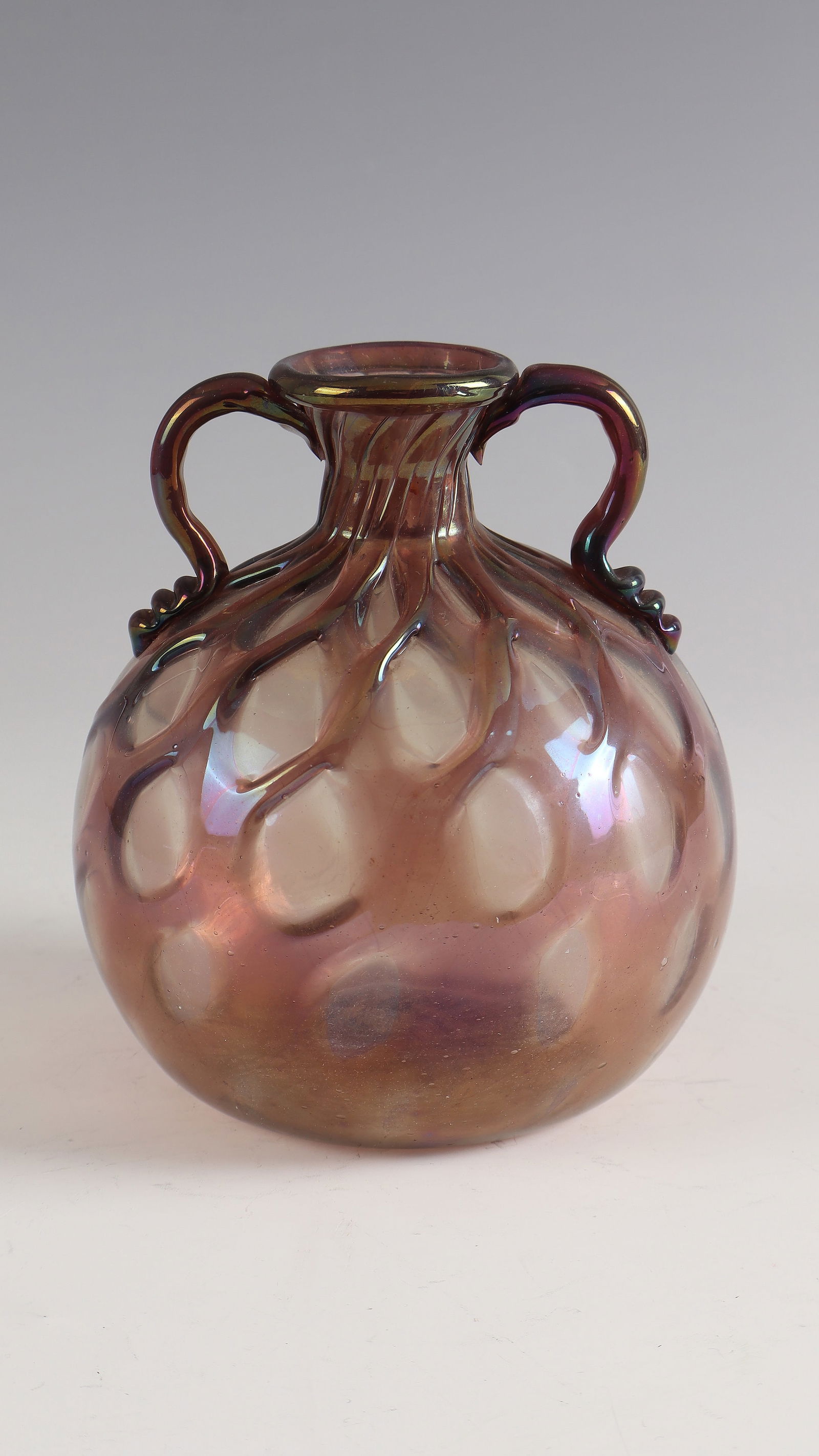 Handle vase: Murano vase with handles, c. 1930 Colourless glass with violet thread melting in relief. Handle appliqués. Vigorously iridescent. H. 14 cm