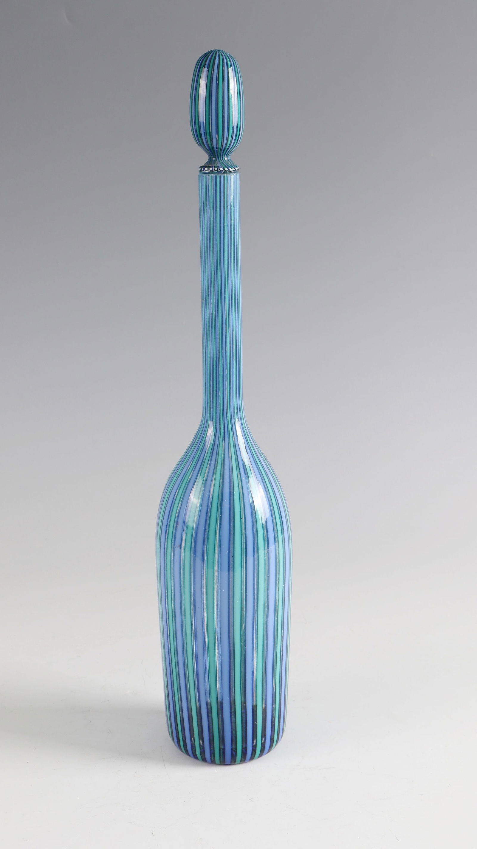 Carafe with stopper ''a canne'': Carafe with stopper ''a canne'' Paolo Venini (design), Venini, Murano, c. 1955 Colourless glass with alternating melted glass rods ('canne') in green and light blue. Original adhesive label of the