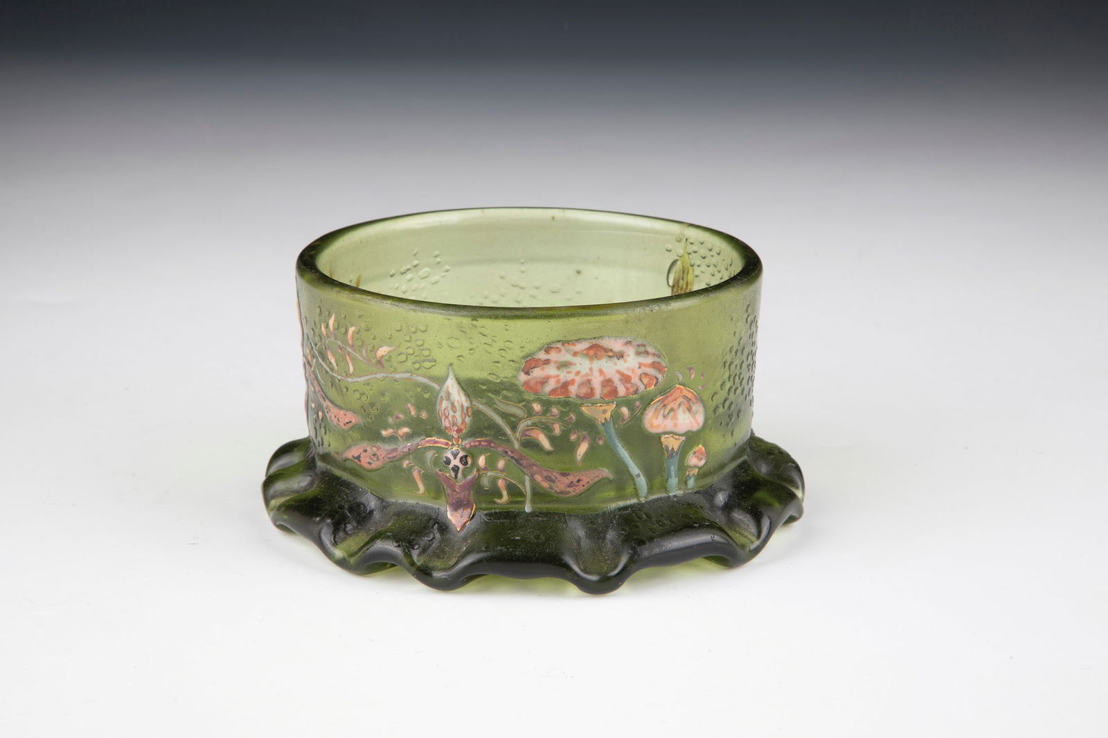 Small bowl: Small bowl Emile Gallé, Nancy, 1892 Green glass. Deeply etched decoration all around, painted in gold and colourful relief enamel: three flowers of the Venus shoe with mushrooms and grasses. Inner