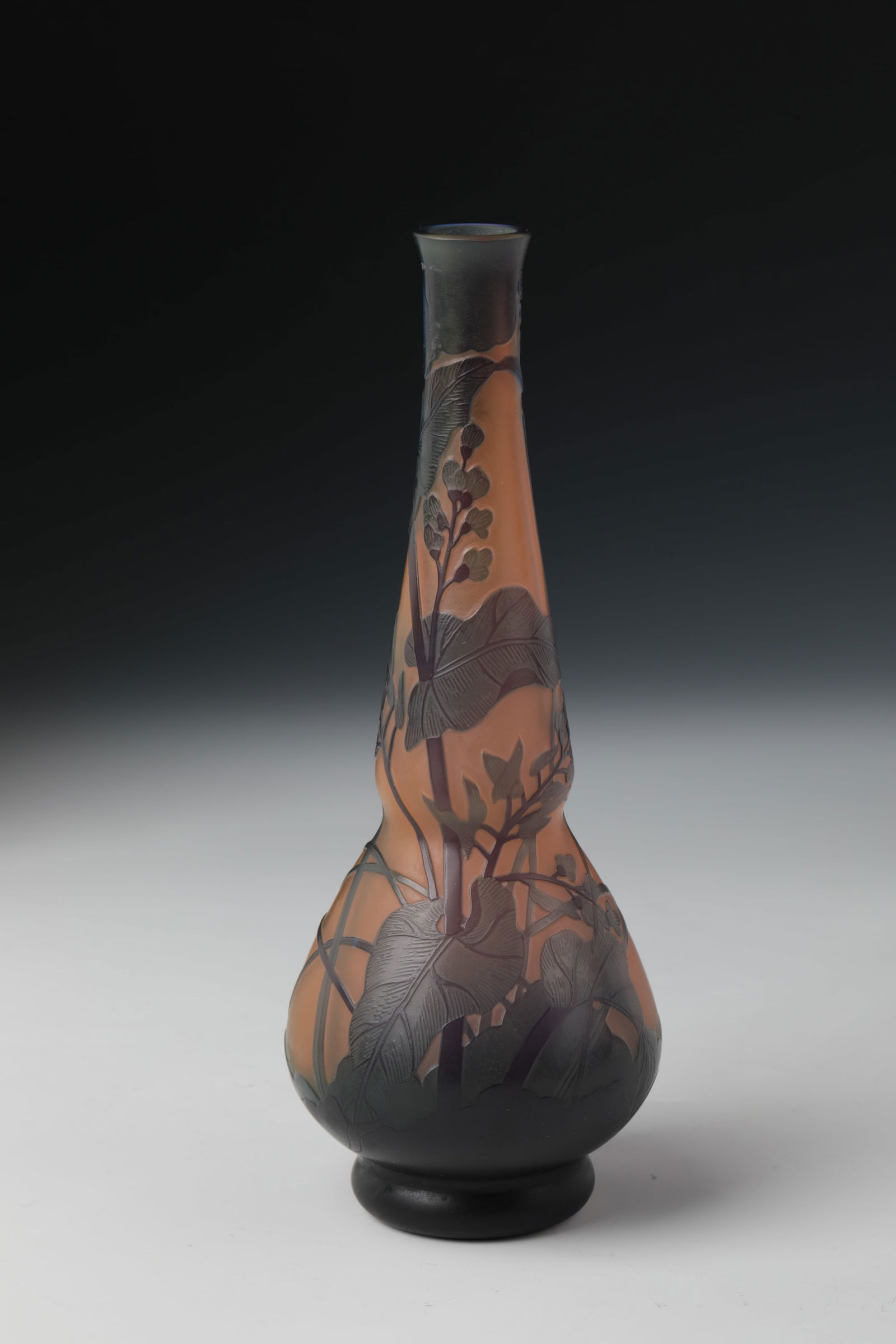 Long-neck vase: Long-neck vase France, d'Argental, Paul Nicolas, (attributed), circa 1915 Colorless, opaline underlaid glass. Bulbous wall with double overlay in salmon colours and violet. Etched floral decoration, i