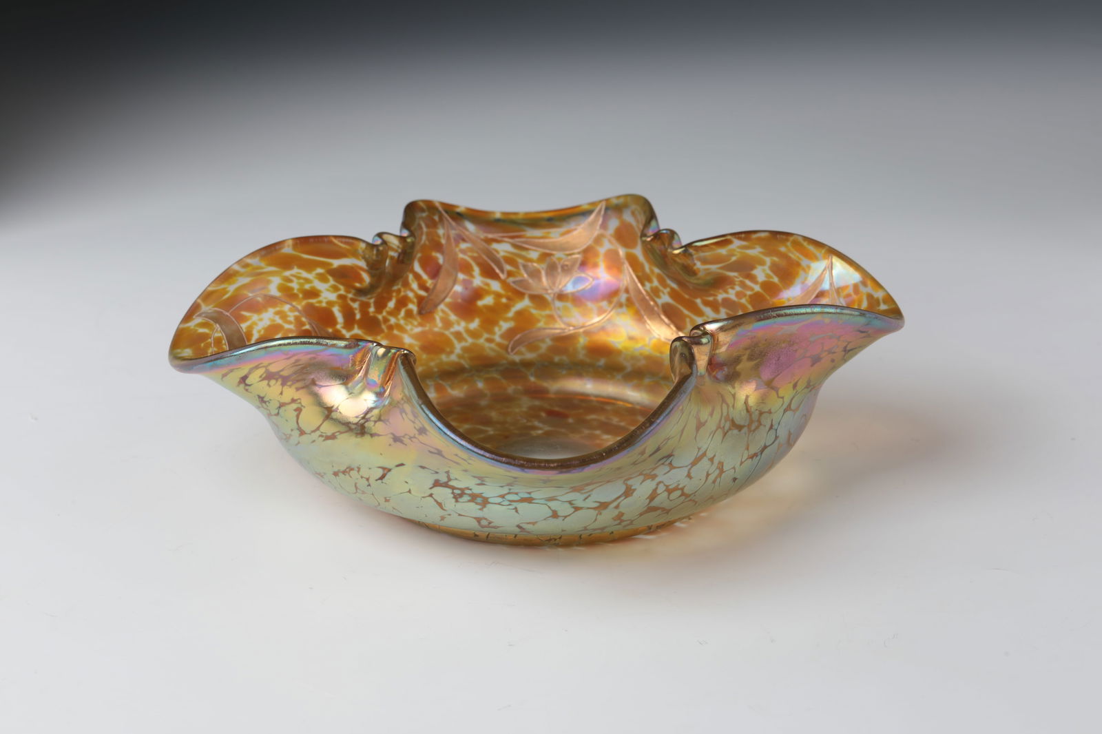 Bowl ''candia Papillon'': Bowl ''candia Papillon'' Loetz Wwe., Klostermühle, c. 1900 Colourless glass underlaid with yellowish opal with crumb melting in silver-yellow. Cloverleaf-shaped pinched muzzle edge. Inside, stylized