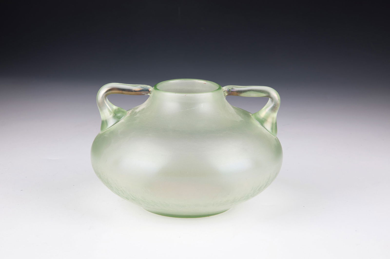 Decorative Handle Vase ''Olympia Smooth'': Ornamental Handle Vase ''Olympia Glatt'' Loetz Wwe., Klostermühle, 1899 Light green, optically blown glass. Two attached handle appliqués on the sides. Matt iridescent. H. 8.5 cm.