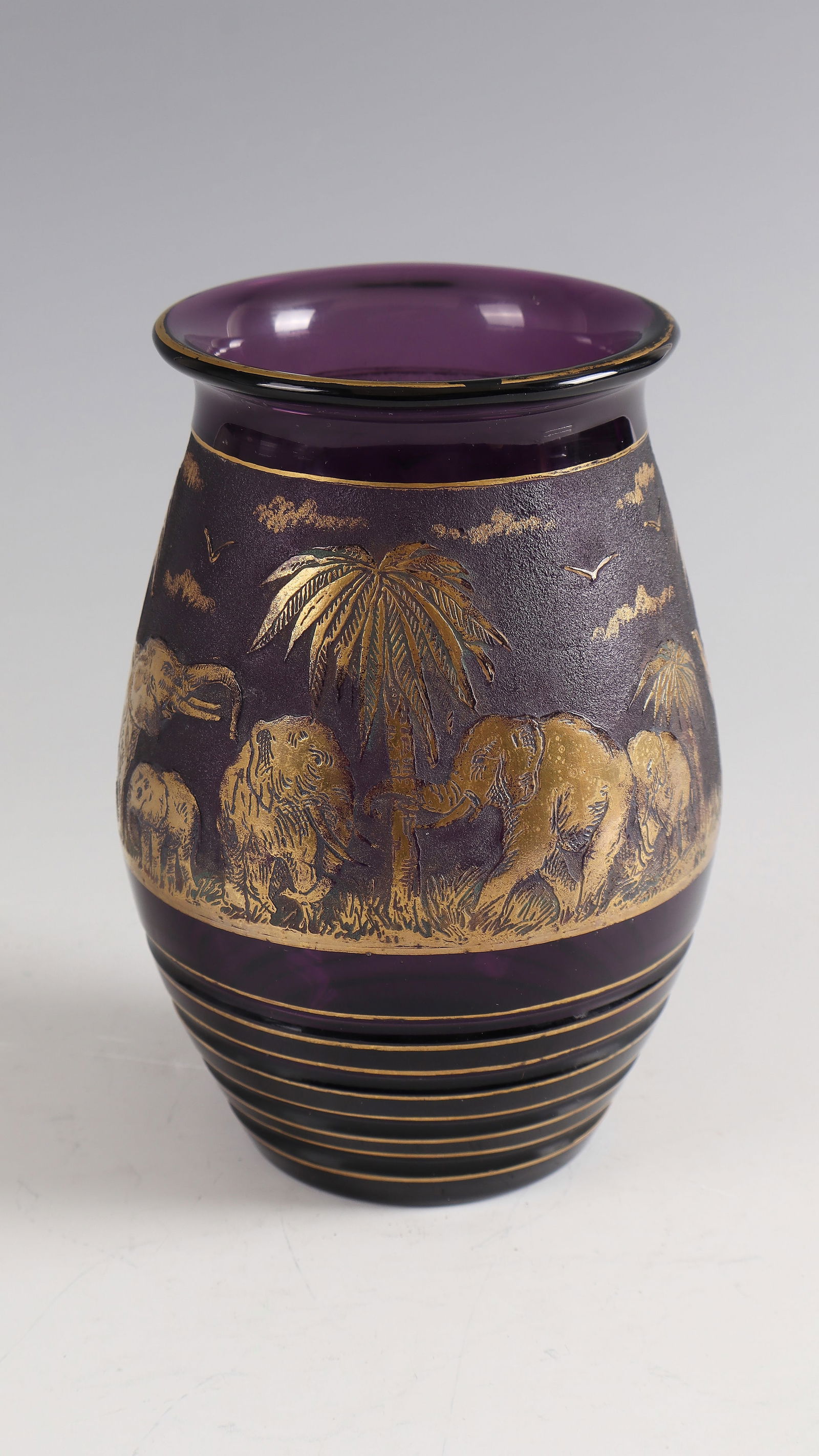 Vase with elephants under palm trees ''Animor'': Vase with elephants under palm trees ''Animor'' L. Moser & Söhne, Karlsbad, 1926 - Design: Rudolf Wels Violet glass, cut, etched and gilded. In the illustration inscribed: R.W. (deeply etched).