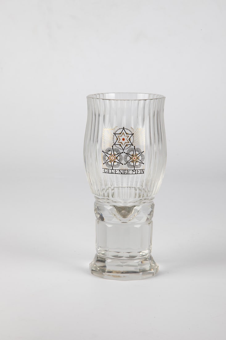 Cup Mug: Steinschönau goblet, c. 1915 Colourless glass. The foot and shaft faceted, the pressed nodus honeycomb faceted. The elongated cuppa polished. On the front with recess of the cut on the cuppa, in