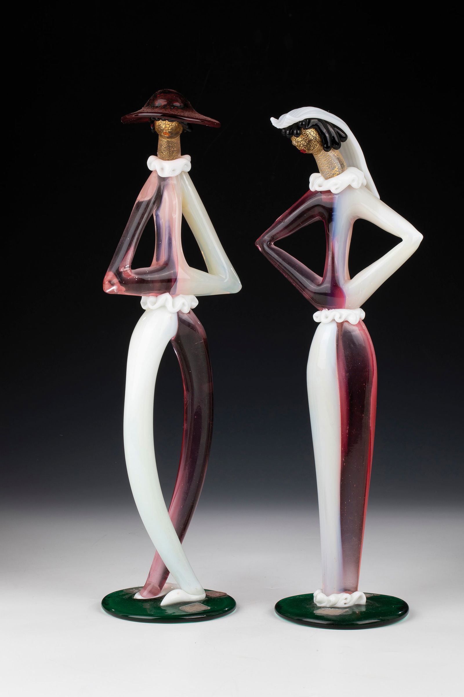 Pair of figures: Pair of figures Anzolo Fuga (design), Arte Vetreria Muranese (A.Ve.M.), Murano, 1956 Colourless, opaque white ('lattimo'), ruby red, pink, green and black glass. Freely formed and fused together,