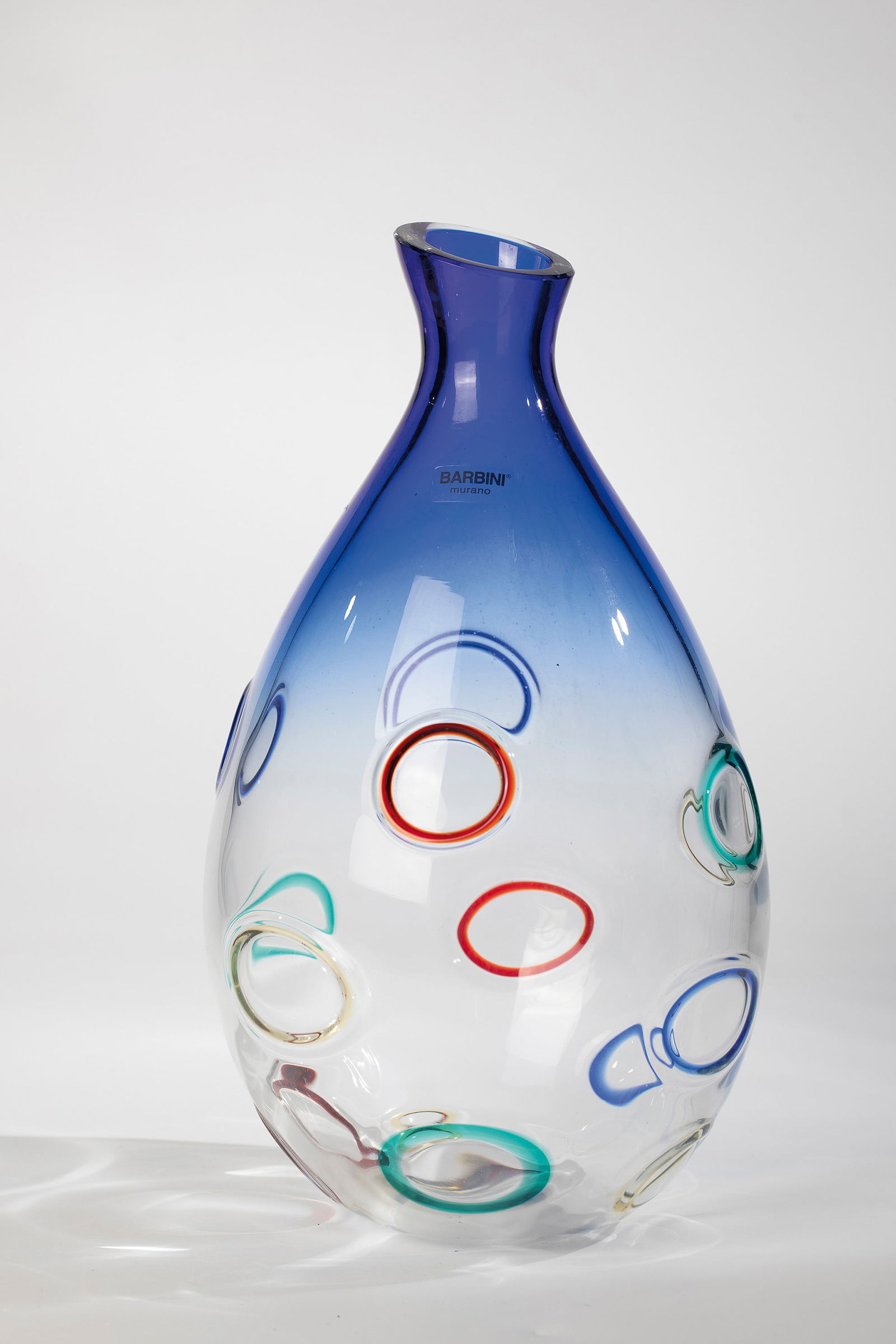 Vase: Vase Barbini, Murano, after 1980 Colourless, thick-walled glass with a partly blue gradient. The outer wall with melted ring murrine in red, yellow, blue and green. Original manufacturer's label.