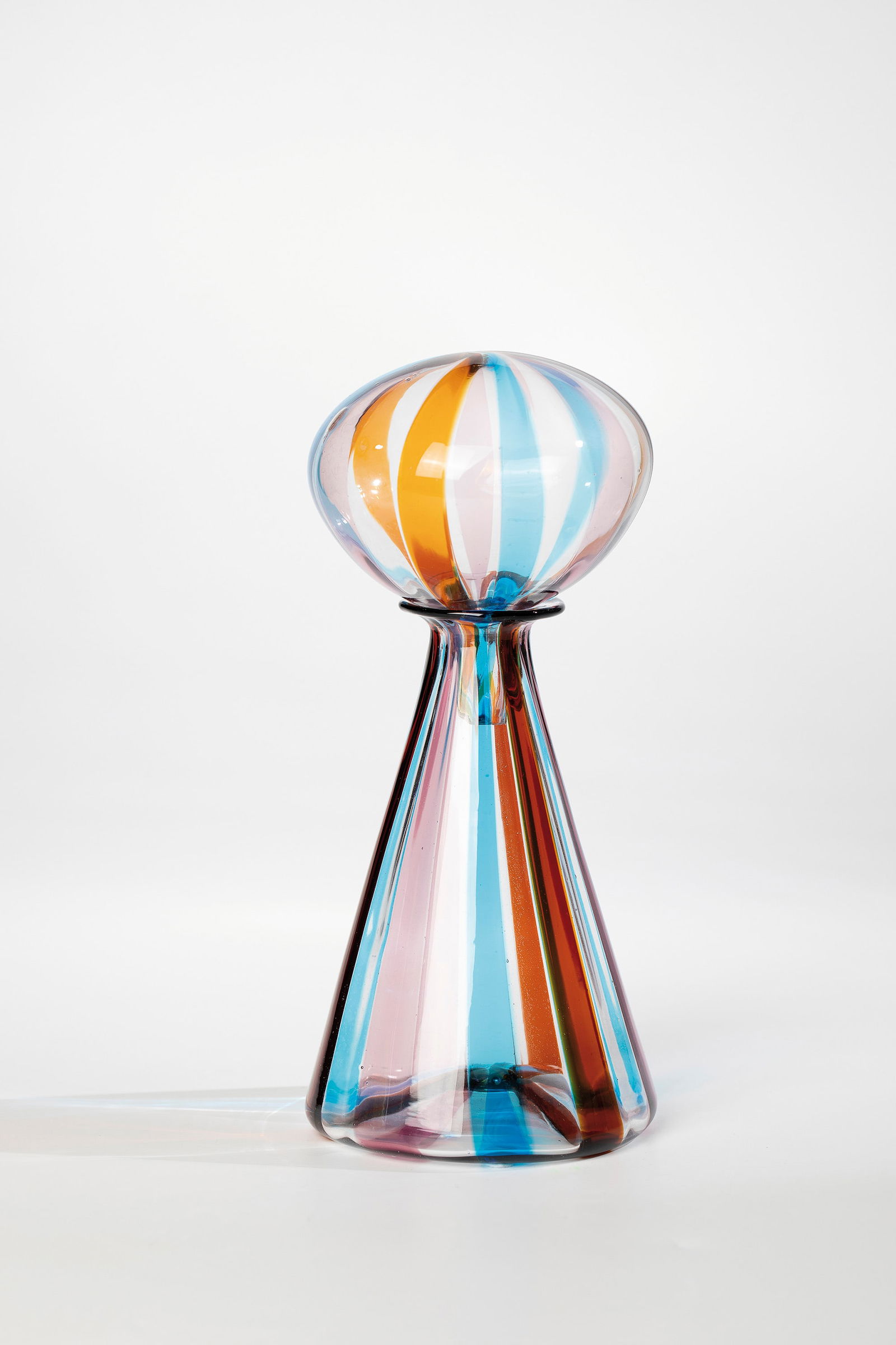 Bottle with stopper ''a fasce'': Bottle with stopper ''a fasce'' Fratelli Toso (attributed), Murano, c. 1965 Colourless glass with vertical ribbon inclusions in old pink, light blue, honey yellow and reddish-brown. H. 22.5 cm.