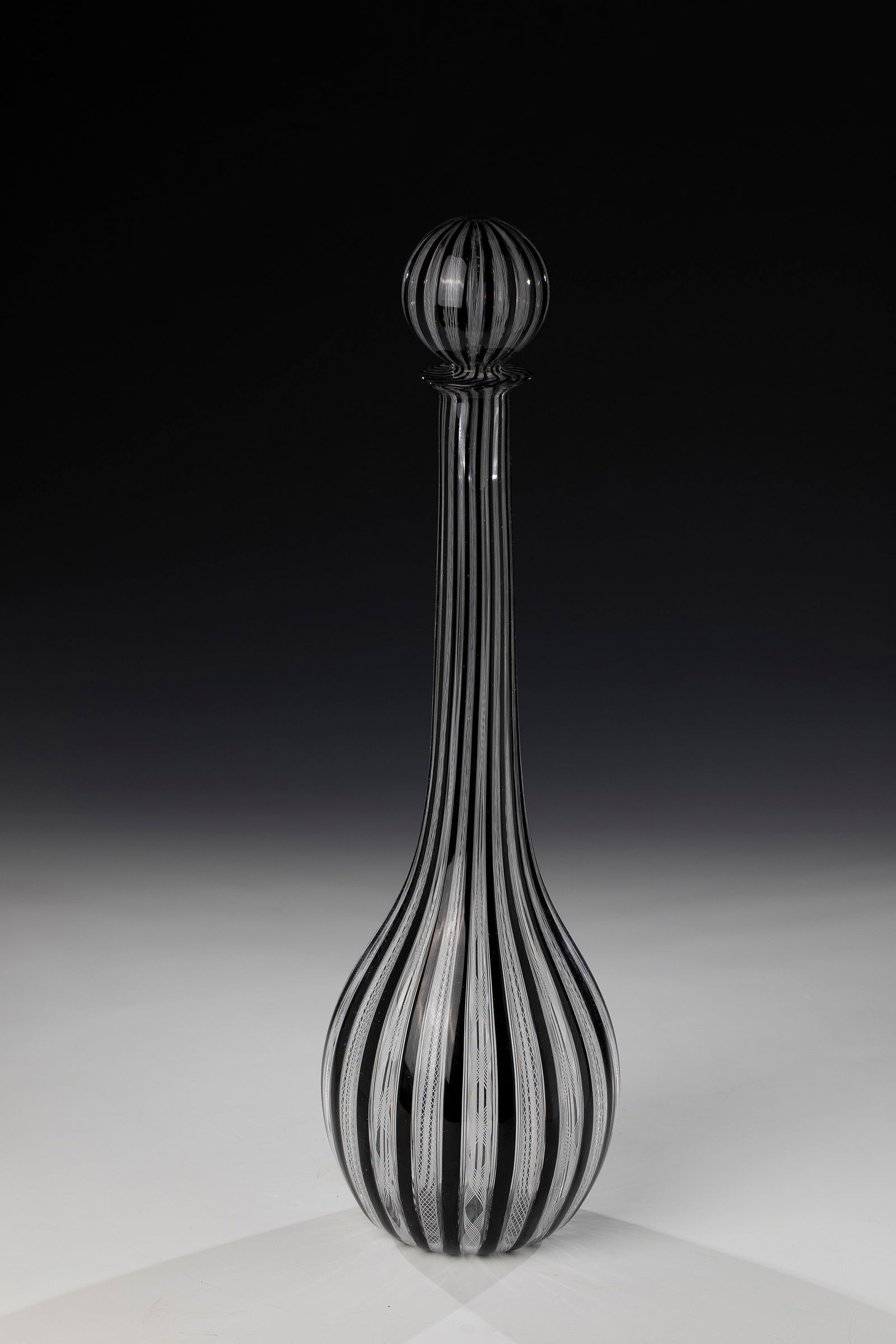 Bottle with stopper ''Zanfirico'': Bottle with stopper ''Zanfirico'' Fratelli Toso (attributed), for Compagnia di Venezia e Murano - Pauly & C., Murano, around 1960 Colourless glass, with alternating ''zanfirico' glass rods in white