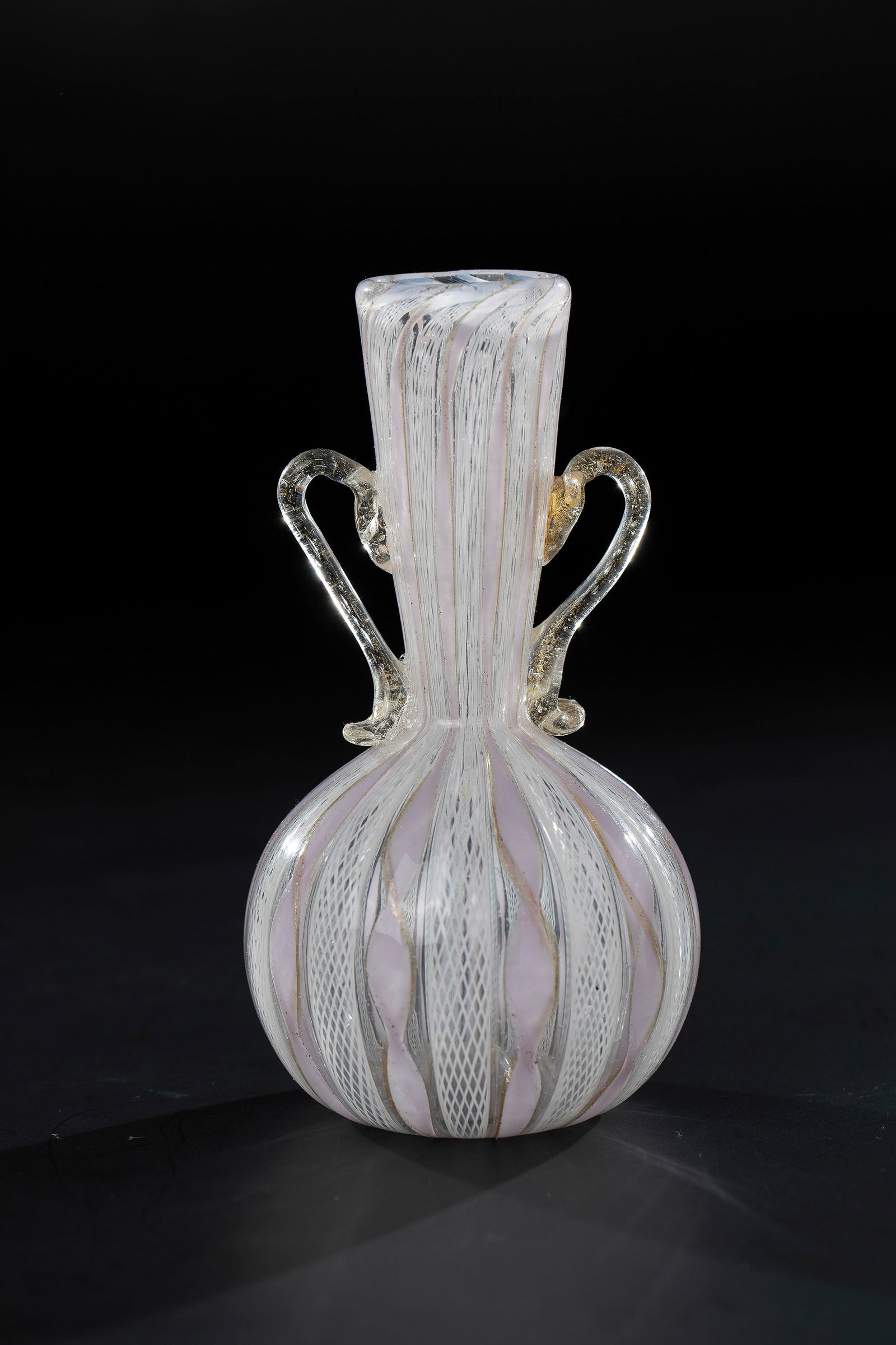 Small Handled Vase ''Zanfirico'': Small Handled Vase ''Zanfirico'' Fratelli Toso (attributed), Murano, c. 1955/65 Colourless glass, with melted glass rods in opaque purple and aventurine and white 'zanfirico'. Attached handles with