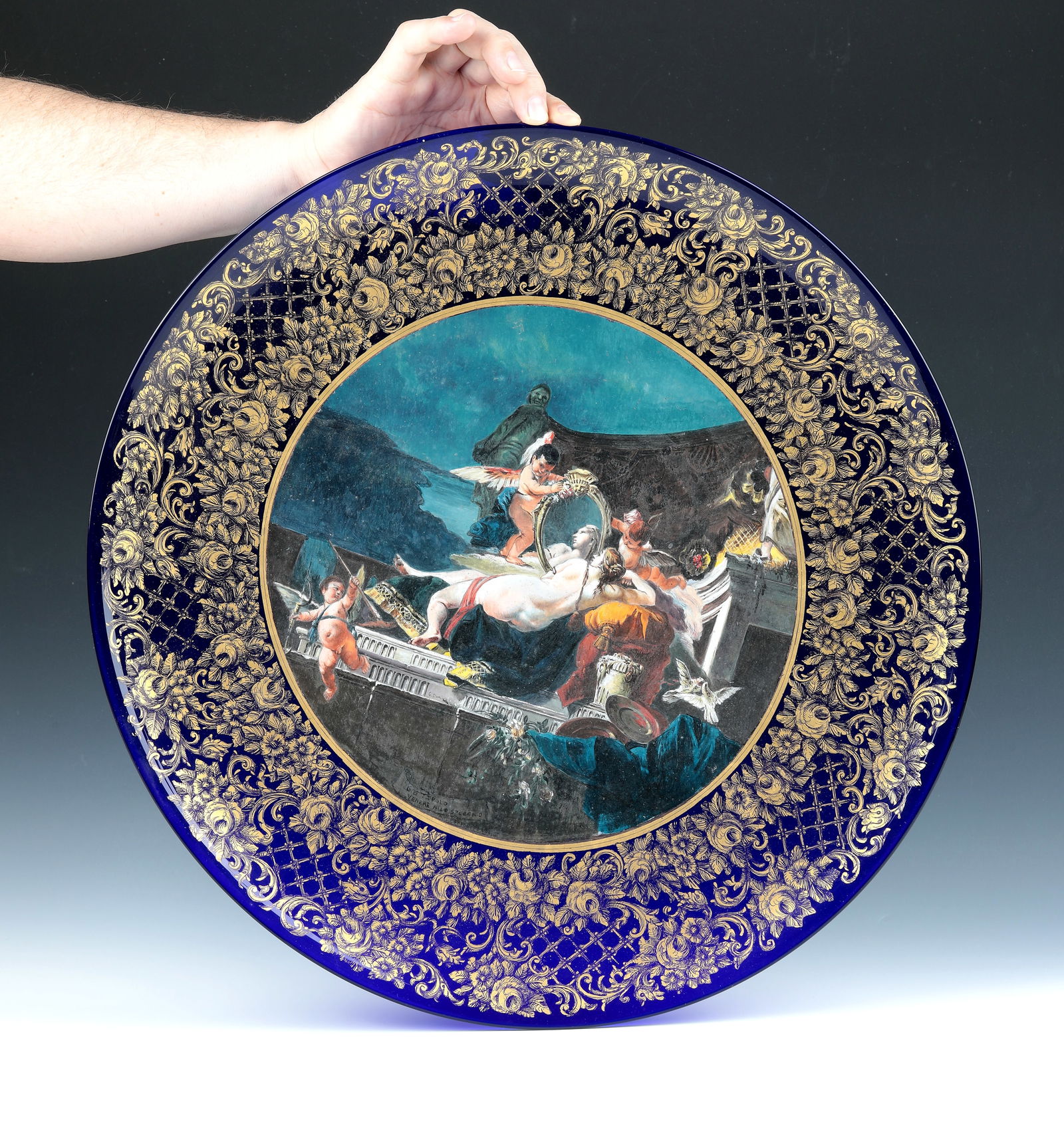 Plate with Mythological Scene ''Venus with Mirror'': Plate with mythological scene ''Venus with mirror'' ARS Cenedese, around 1993 Cobalt blue glass with finely executed polychrome depiction in the mirror: Venus with mirror (after a painting by