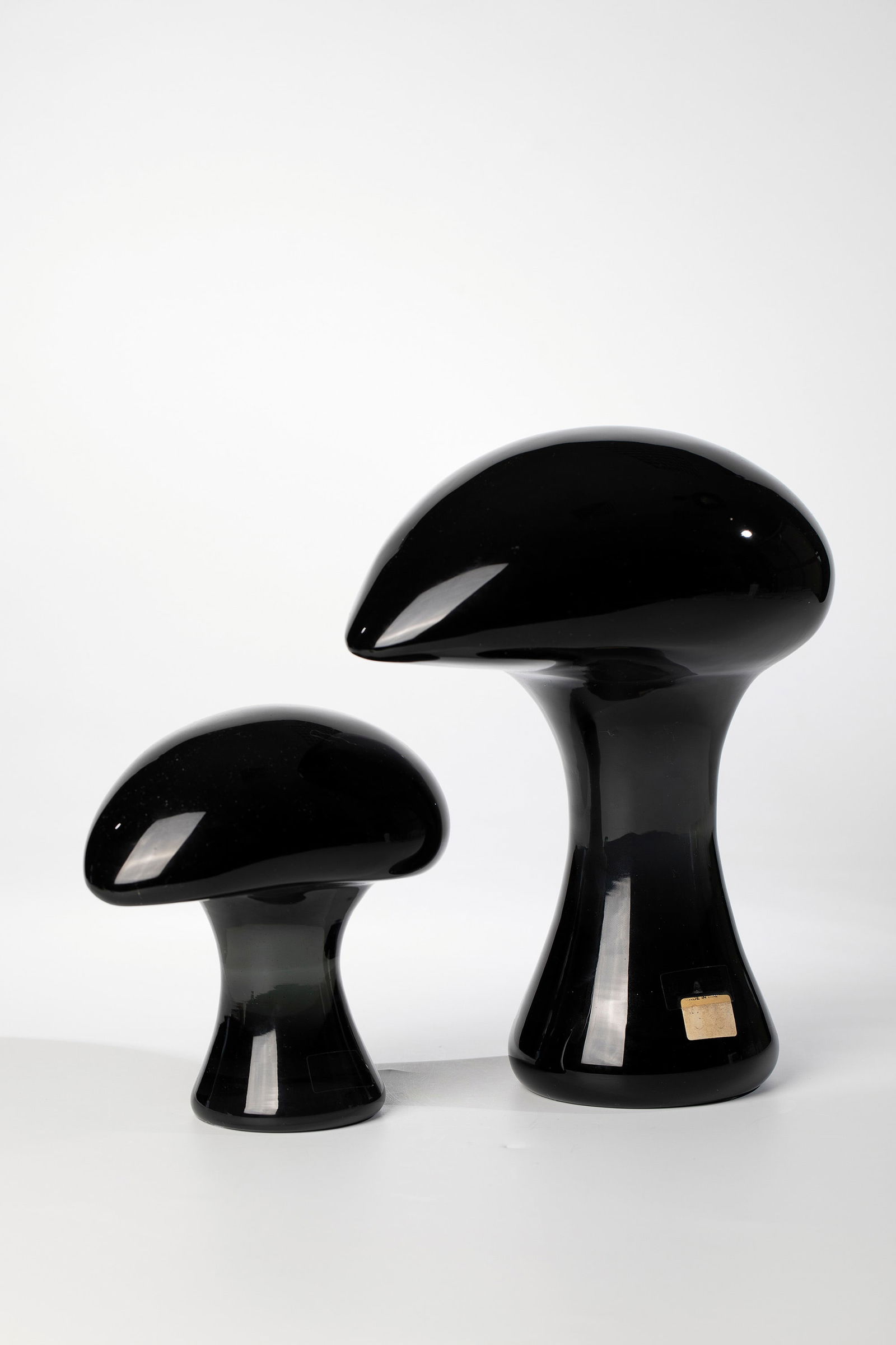 Two mushroom objects: Two mushroom objects attributed to Archimede Seguso (design), Seguso Vetri d'Arte, Murano, 1980-90 Amethyst-coloured and grey-green glass, respectively. Mushroom-like shaping. Original manufacturer's