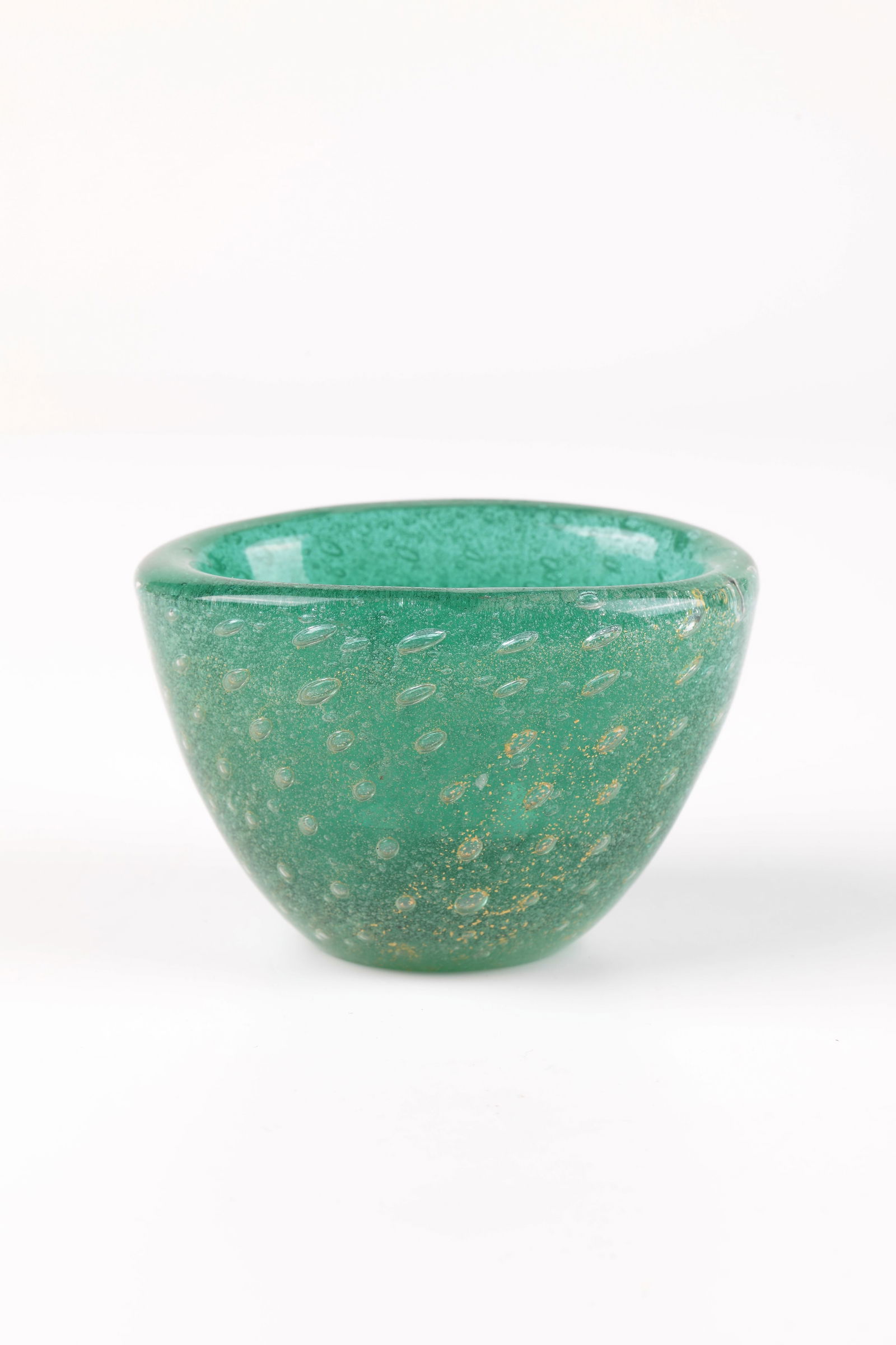 Bowl ''a bollicine'': Bowl ''a bollicine'' Carlo Scarpa (design), Venini, Murano, c. 1934 Colourless, green underlaid glass ('sommerso'), partly with gold foil melting and pierced bubbles. Inscribed in the bottom: venini m