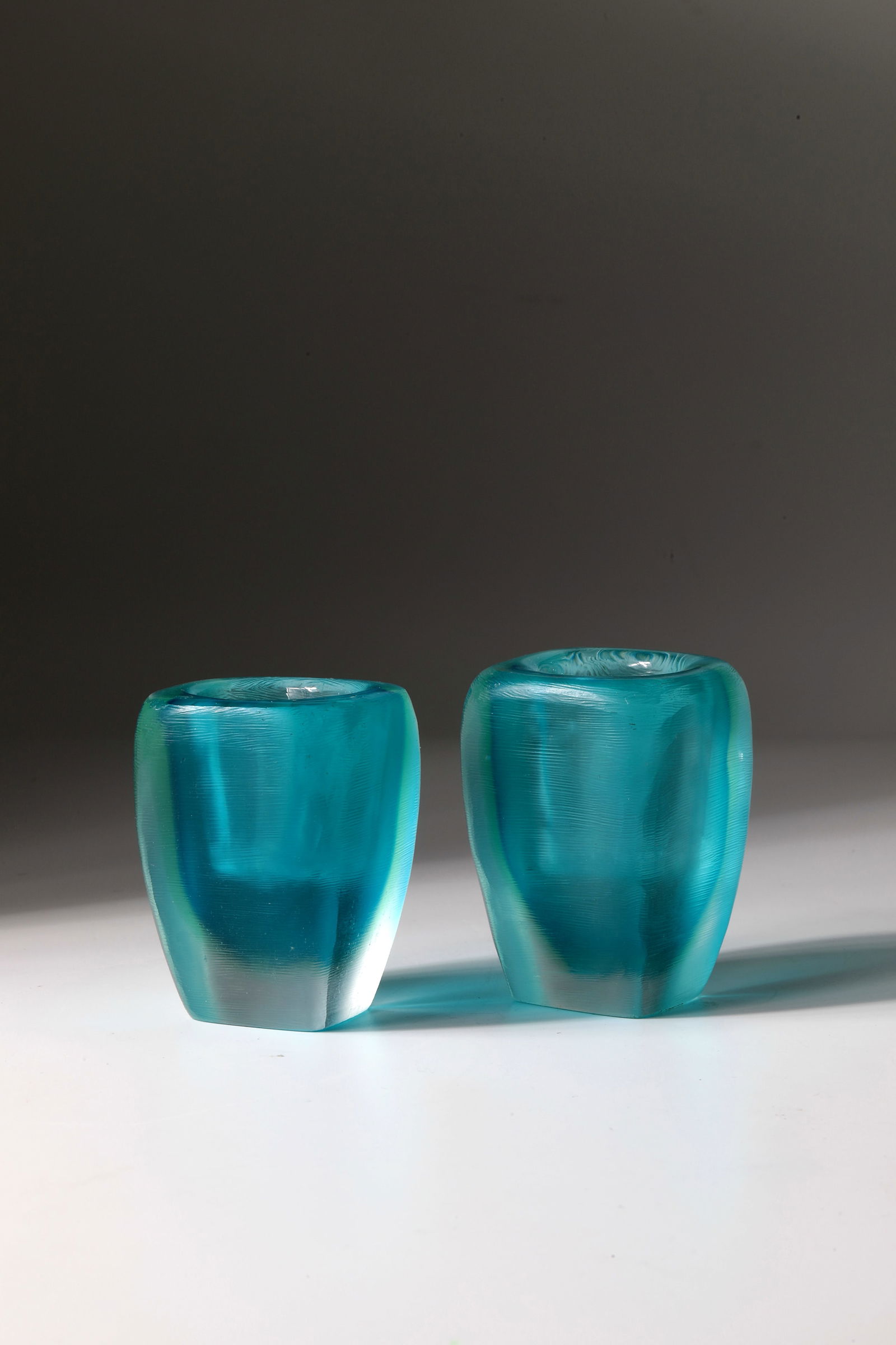 Pair of Candlesticks ''Inciso'': Pair of Candlesticks ''Inciso'' Paolo Venini (Design), Murano, circa 1956 Colourless glass with aquamarine underlay. The entire outer wall was reworked with fine horizontal grooving in matt sharp cut