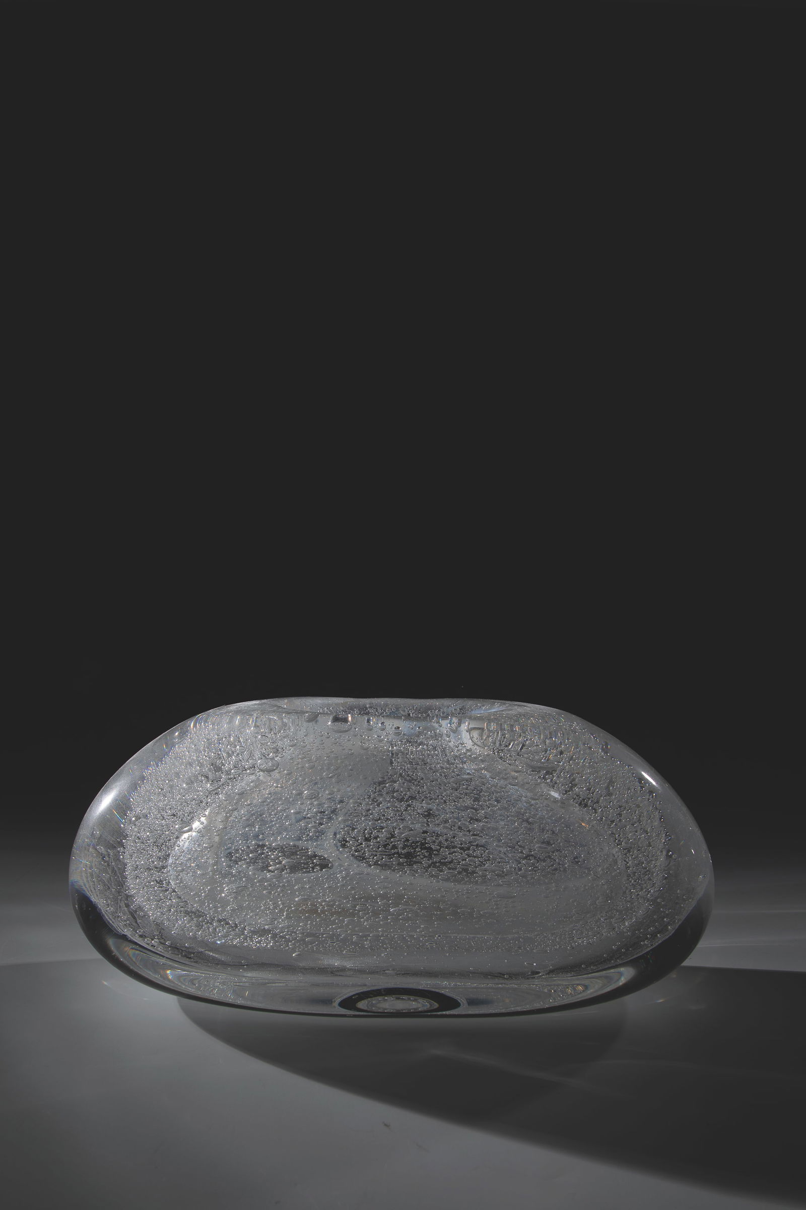 Vase: Vase Floris Meydam (design), Leerdam, 1965 Colorless, thick-walled glass with minimal streaks in opaque white and pierced irregular air bubbles. Under the ground in diamond crack inscribed: Leerdam