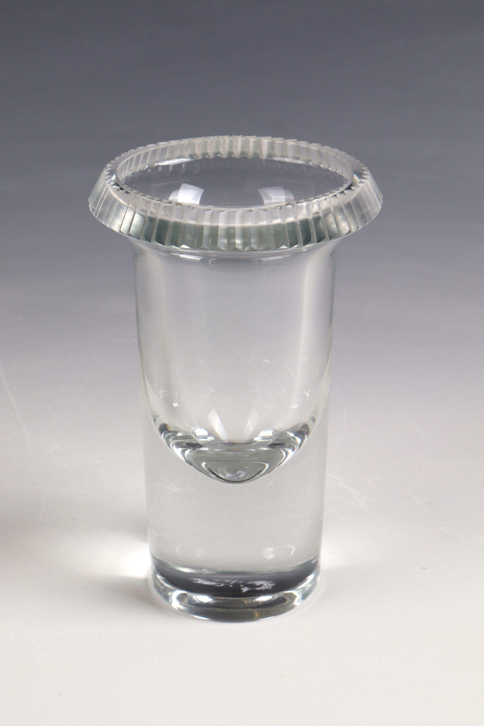 Vase object: Vase object Ludvika Smrckova Thick-walled, colourless glass with notched finish at the edge of the mouth. Signed in engraving ''L.Smrckova'' in the bottom. H. 14 cm.