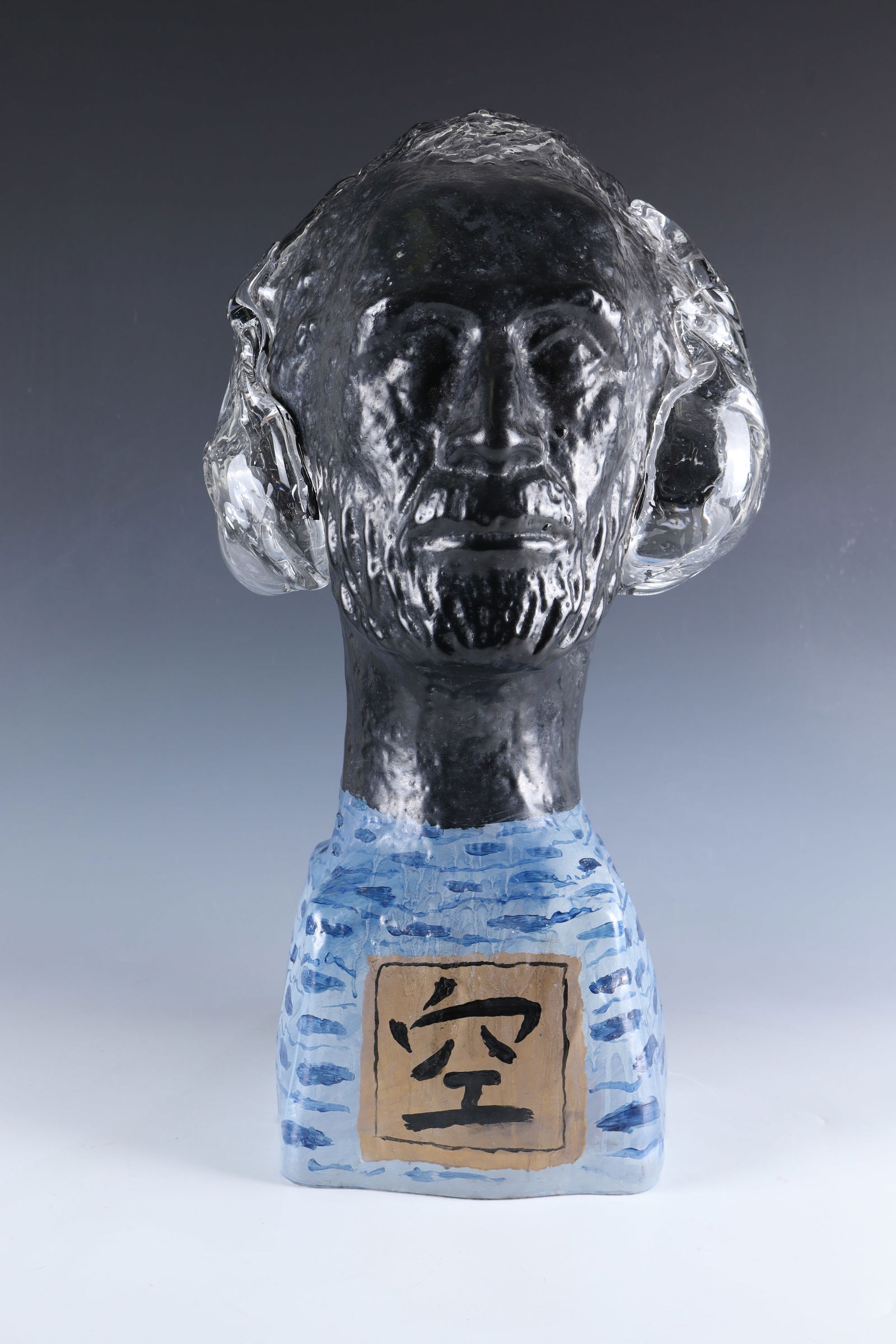 Head ''My love to buddha'': Head ''My love to buddha'' Erwin Eisch, 2002 Colourless glass, mould-blown, painted with enamel. Signed and dated in engraving: E. Eisch 02. H. 91.5 cm. Lit.: K. Eisch-Angus/I. Kohl/K. Schrott und