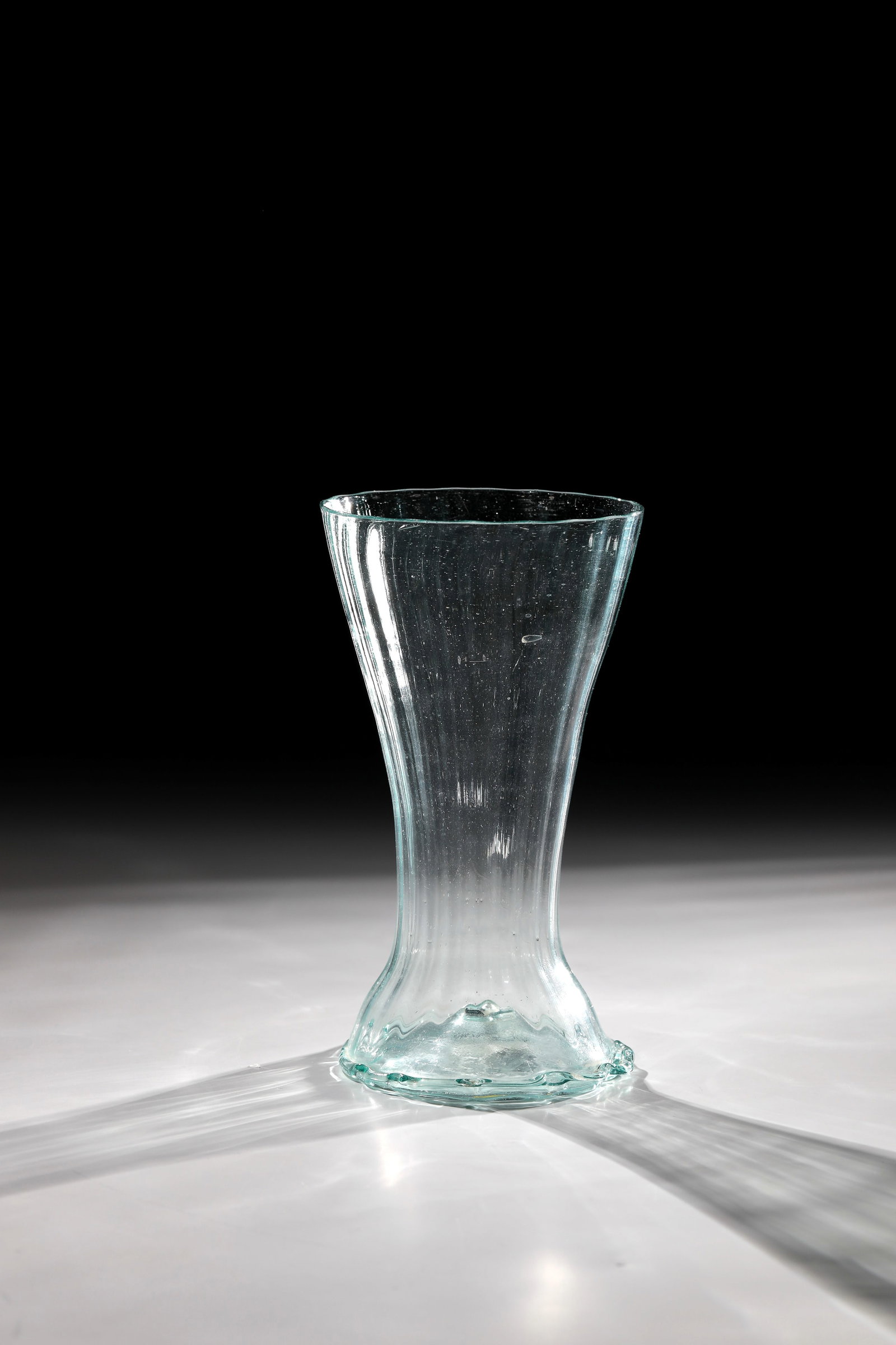 Rare ribbed cup: Rare ribbed cup Germany, 17th century Light green, thin-walled, longitudinally optically blown glass with fine bubbles and inclusions. Highly pierced floor with demolition. Applied, multiple irregular