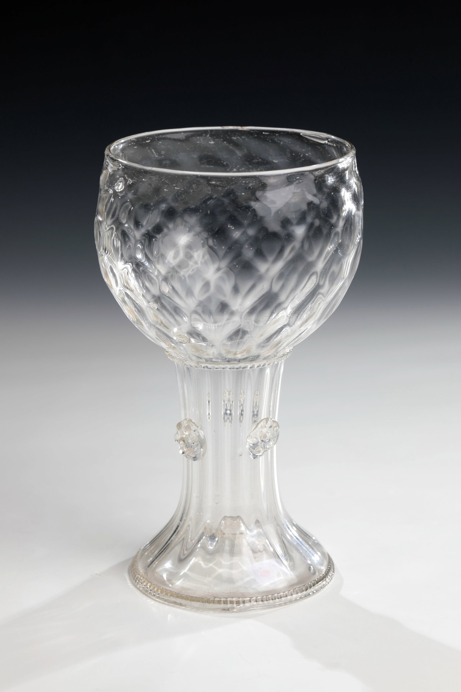 Heilbronn Romans: Heilbronn Romans Southern Germany, 17th century Colourless glass. Raised floor with demolition. Applied, pinched glass thread as a stand ring. Longitudinally ribbed shaft with three appliquéd berry n