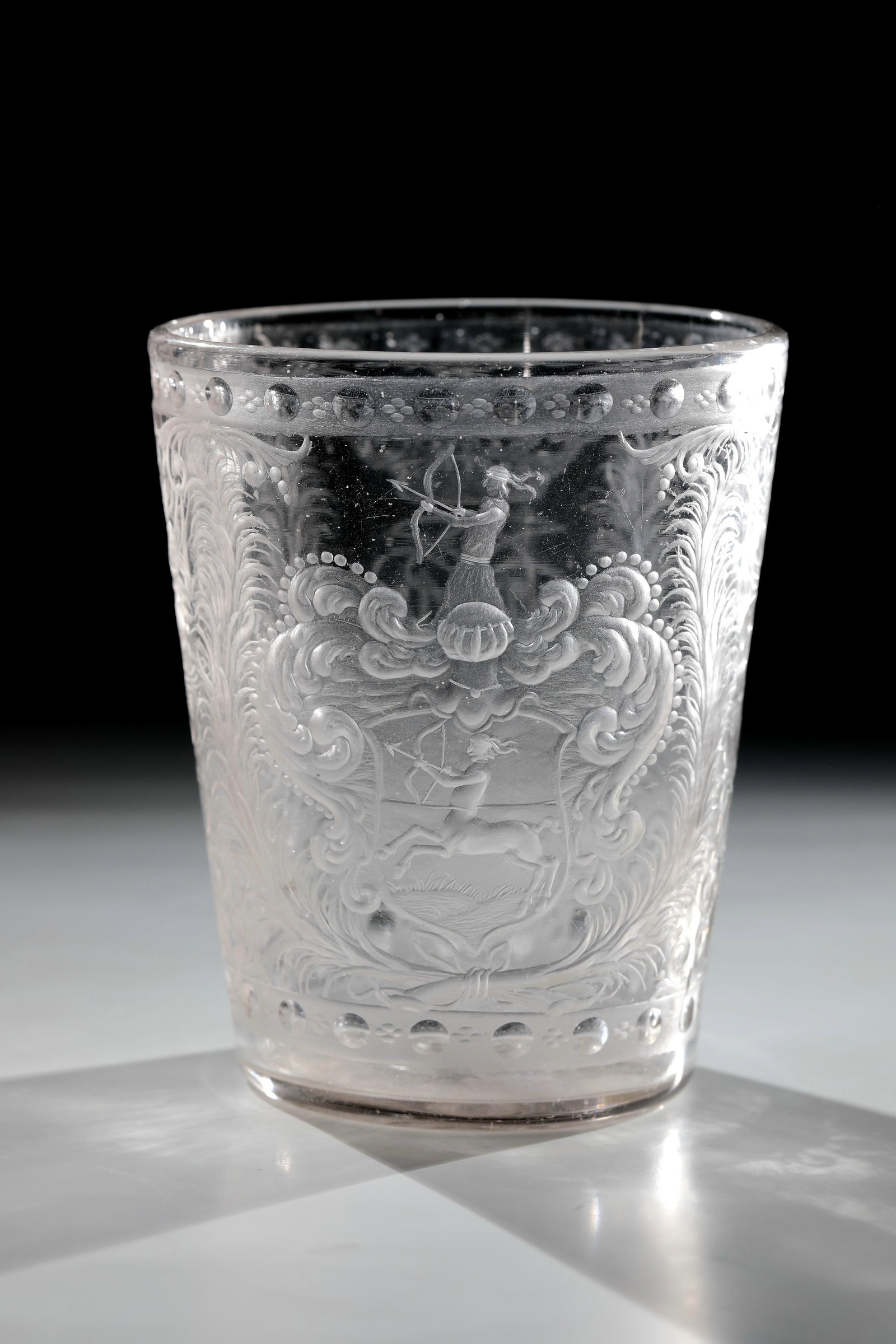 Goblet with coat of arms of Johannes von Milich: Beaker with coat of arms of Johannes von Milich Silesia, Giant Mountains, E. 17th century Colourless, thick-walled glass with a partially flared and very deep cut. Flat bottom with sanded demolition. 
