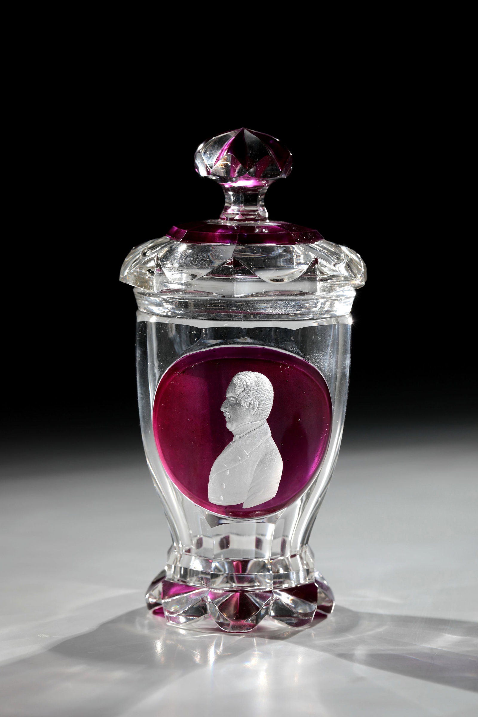 Portrait Mug with Lid: Portrait cup with lid North Bohemia, August Geißler c. 1835-1840 (attributed) Colourless glass. Bottom with roller grind alternating violet glazed, foot edge sanded to fit. Frontal on the eight-fold