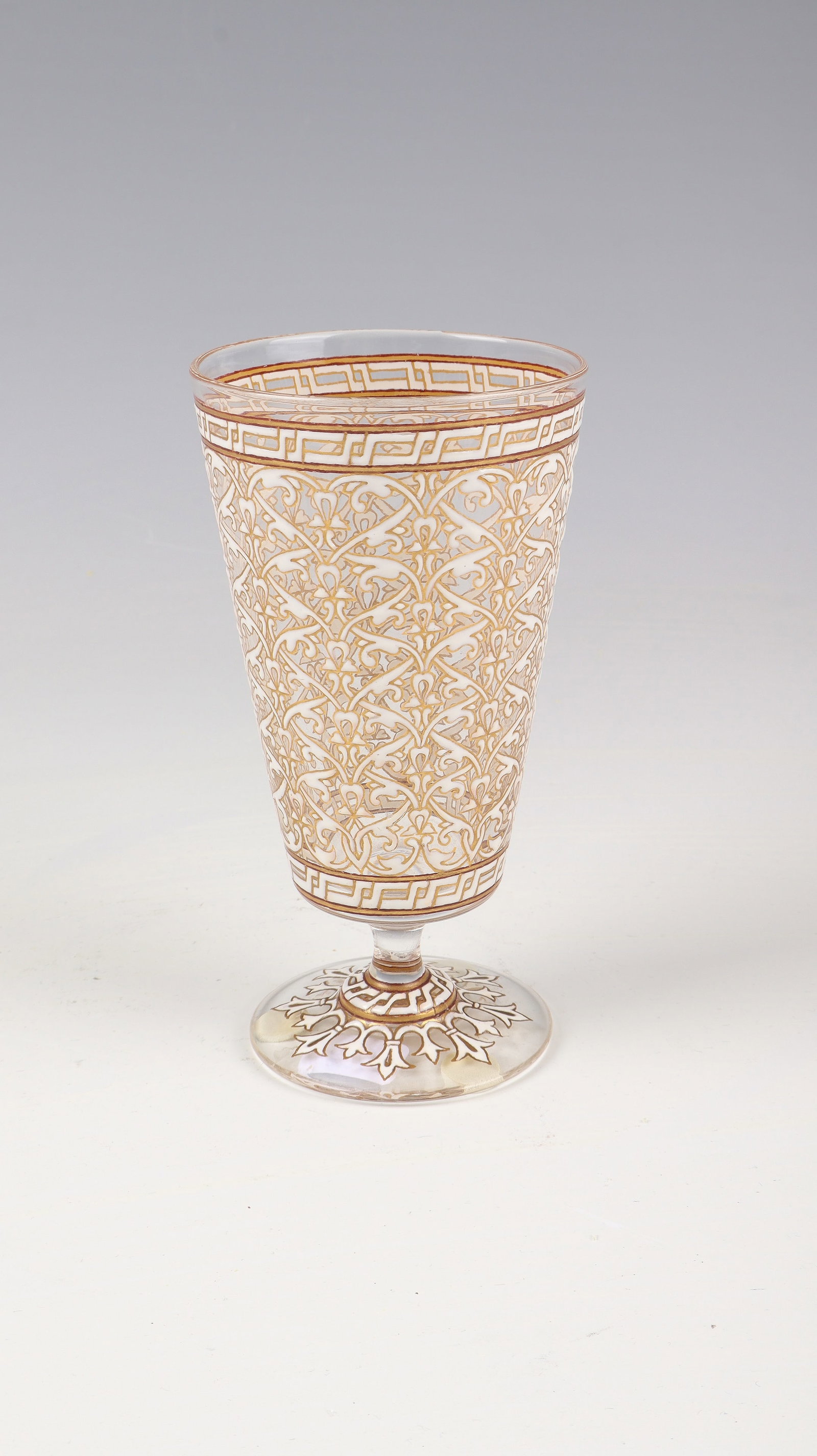 Cup glass: Philippe-Joseph Brocard goblet glass, Paris, 1876 Colourless glass with very finely executed white opaque enamel painting. Decor: Flower tendrils, rosettes and ornamental bands in a circumferential mo